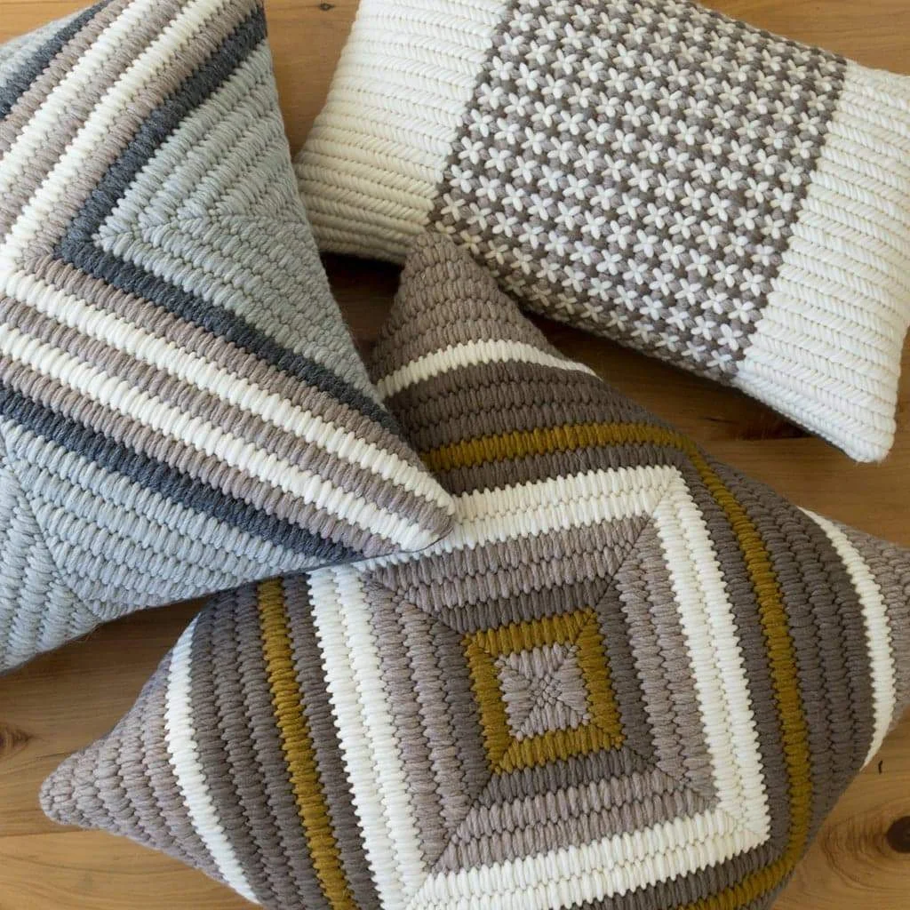 Artisan made hand stitched needlepoint textured pillows.