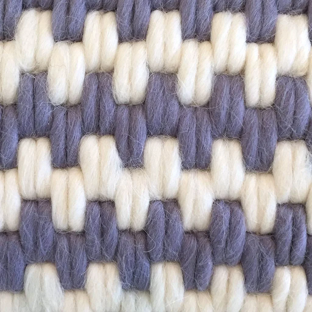 Detail view of artisan made hand-stitched textured pillows in lavender stripe. Wool and linen.