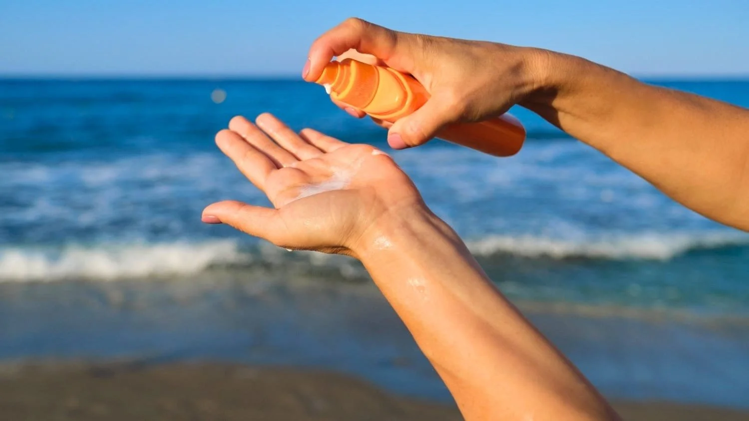 Woman applying sun protection lotion