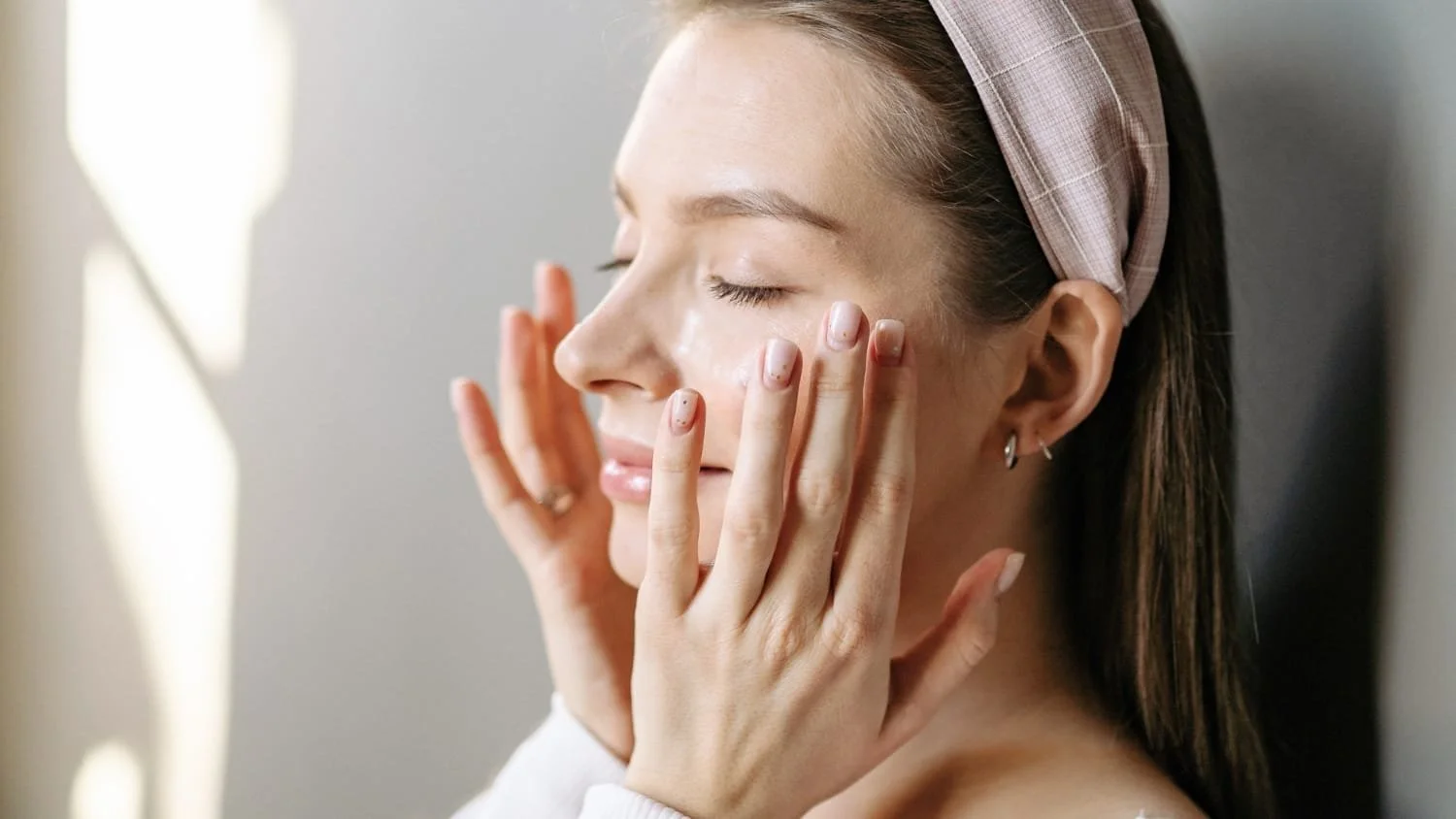 Woman applying skincare with probiotics on face