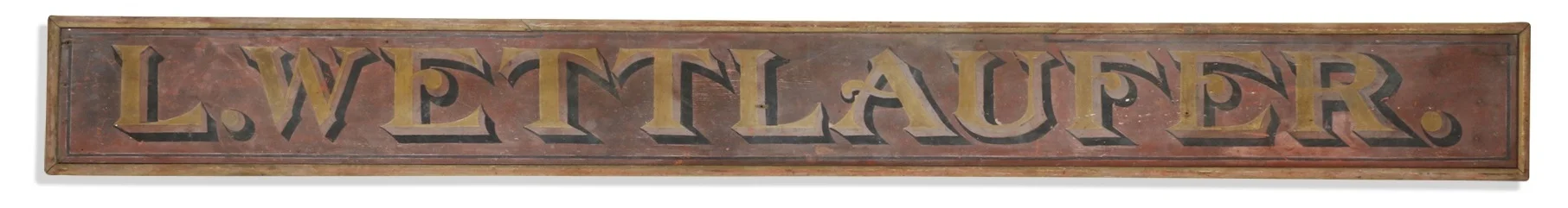 A wooden painted trade sign made for Ludwig (Louis) Wettlaufer in 1902. This sign was safely tucked away in Eileen’s general store since it was removed from the building. Estimate $1200-1500.