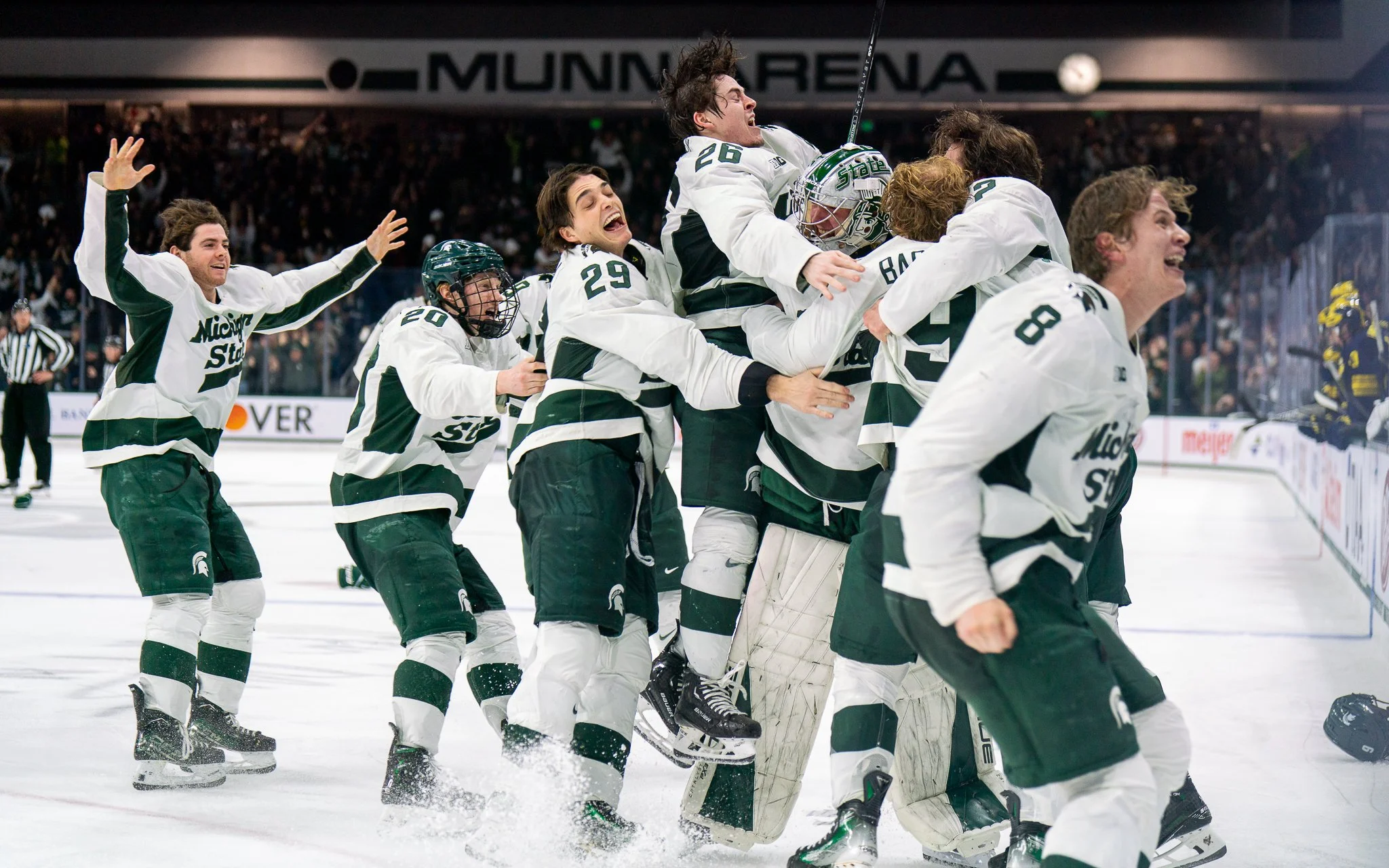 Michigan State players celebrate on the ice following a 5-4 overtime victory against Michigan in the Big Ten Hockey Tournament championship game at Munn Ice Arena in East Lansing, Mich., Saturday, March 23, 2024. Freshman defenseman Patrick Geary sco