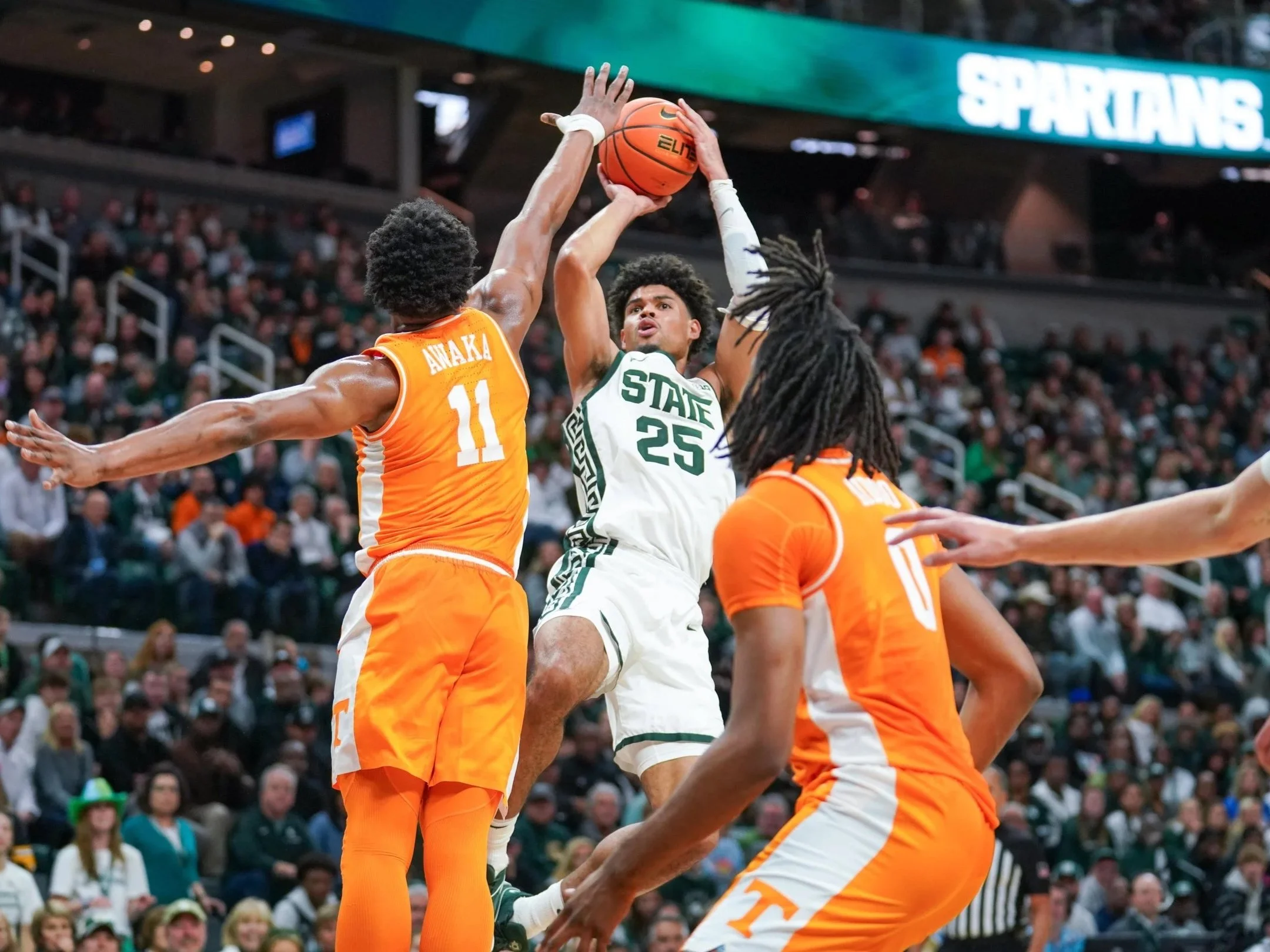 Michigan State forward Malik Hall (25) shoots a fadeaway jumper over Tennessee forward Tobe Awaka (11) during a charity exhibition game at the Breslin Center in East Lansing, Mich., Sunday, Oct. 29, 2023. The matchup between the No. 4 Spartans and No