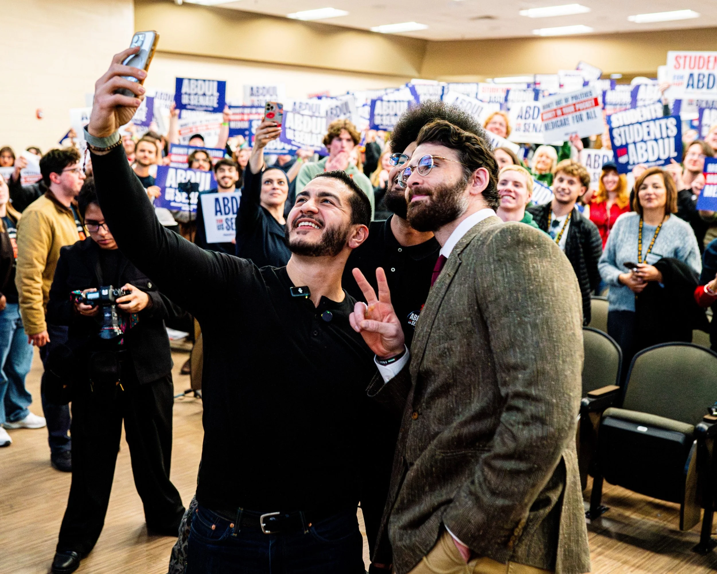 U.S. Senate candidate Abdul El-Sayed, left, takes a selfie with political commentator Hasan Piker during a campaign rally at Michigan State University in East Lansing, Mich. on April 7, 2026. The event focused on mobilizing young voters around progre
