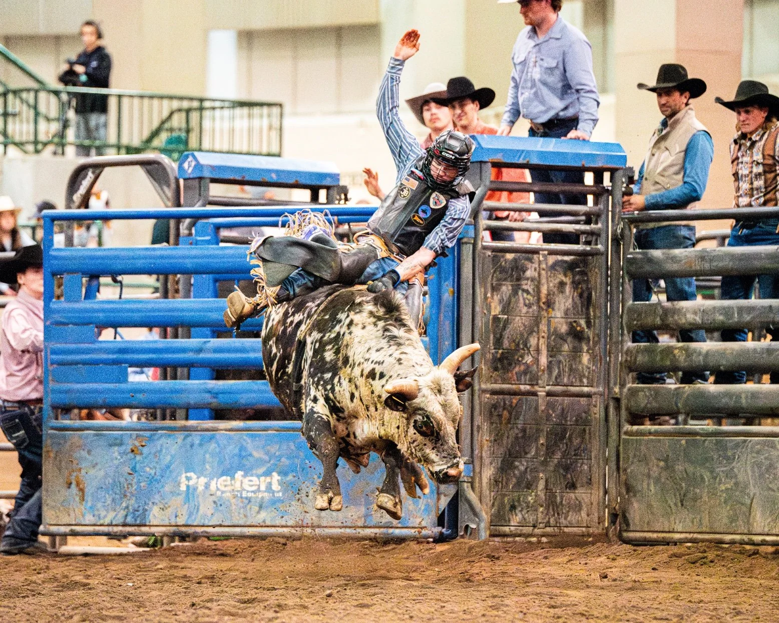 Cody West stays centered on a bucking bull as it launches completely airborne during the Great Lakes Championship Bull Riding finals at the Michigan Horse Expo inside the MSU Pavilion.