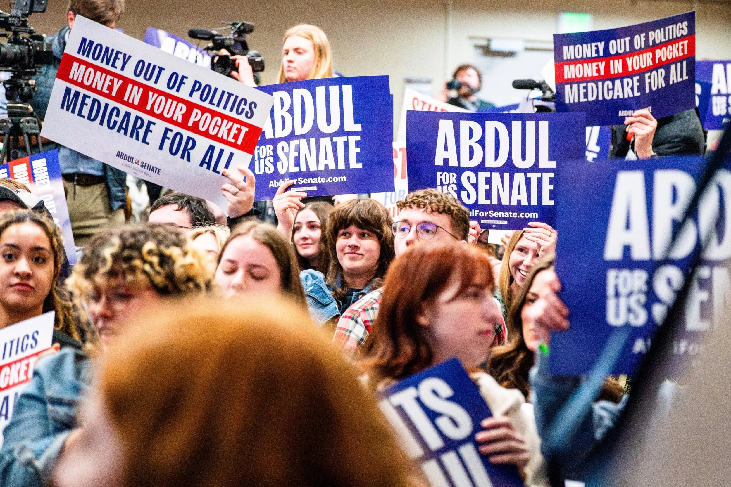 Students cheer and display campaign signs in Anthony Hall at Michigan State University in East Lansing, Mich., Tuesday, April 7, 2026.