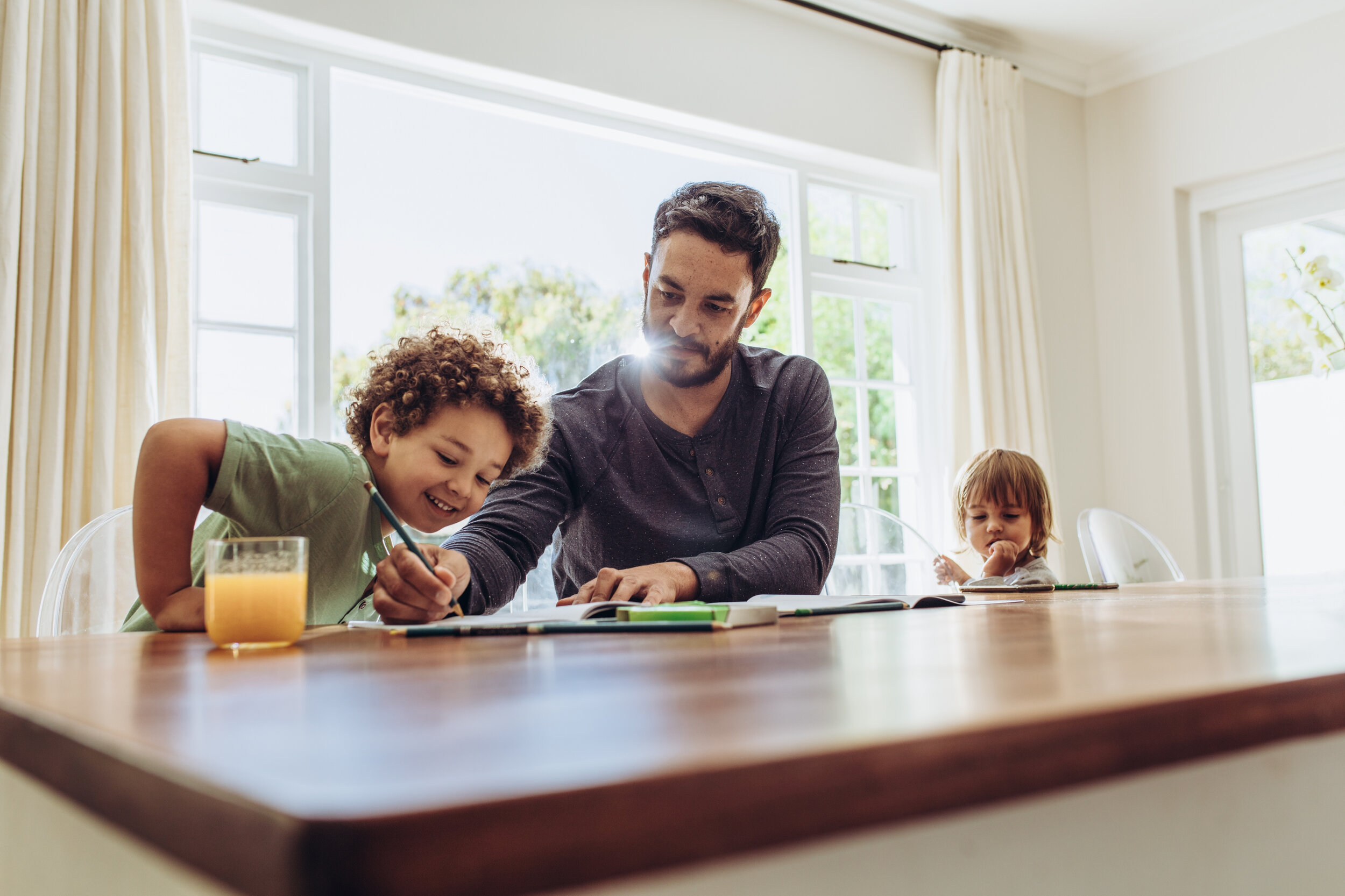 Canva - Father Helping His Child in Doing Home Work.jpg