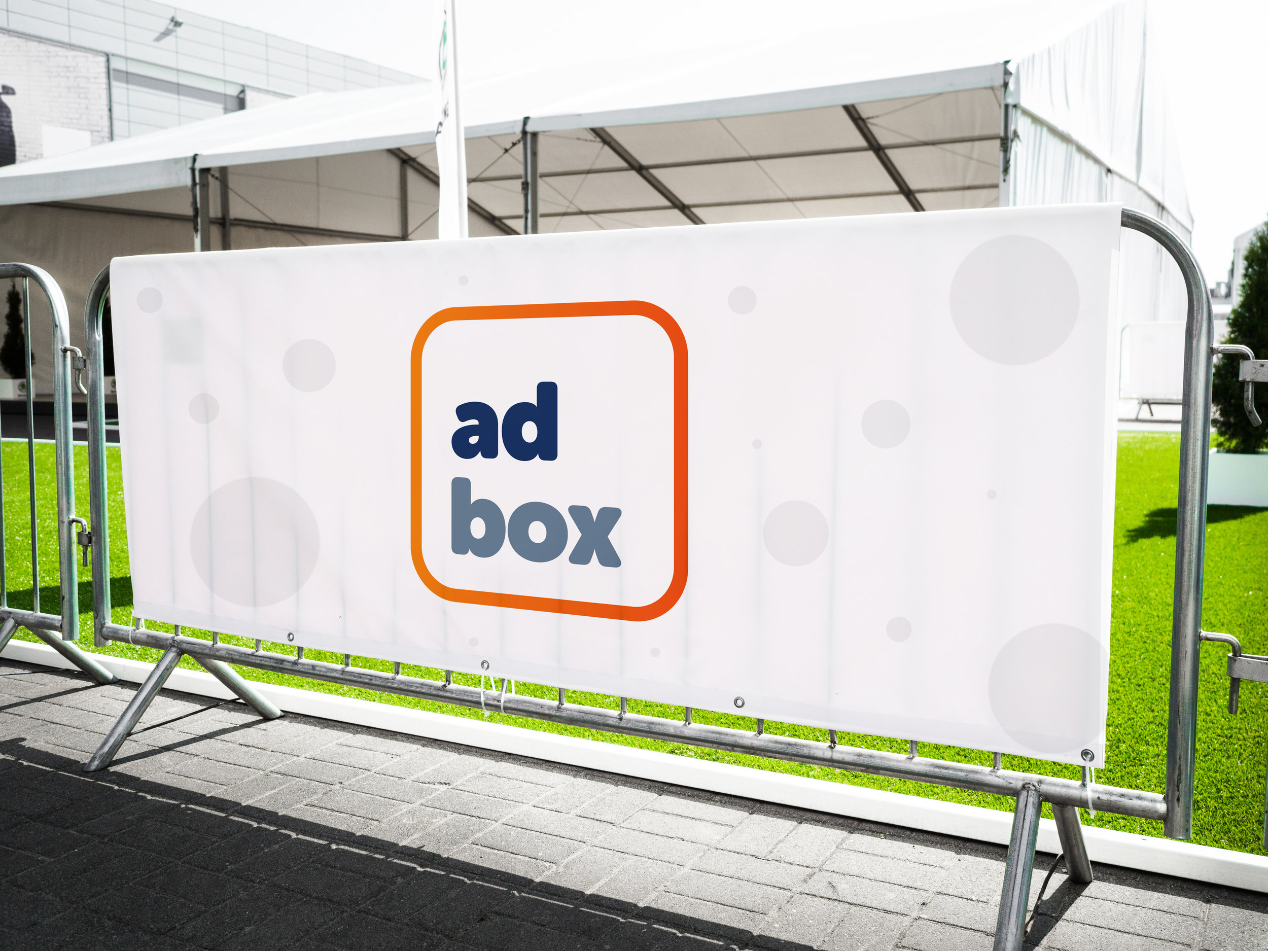 white mesh banner of Ad Box advertising in Miami printed by Print Hub a Miami sign shop