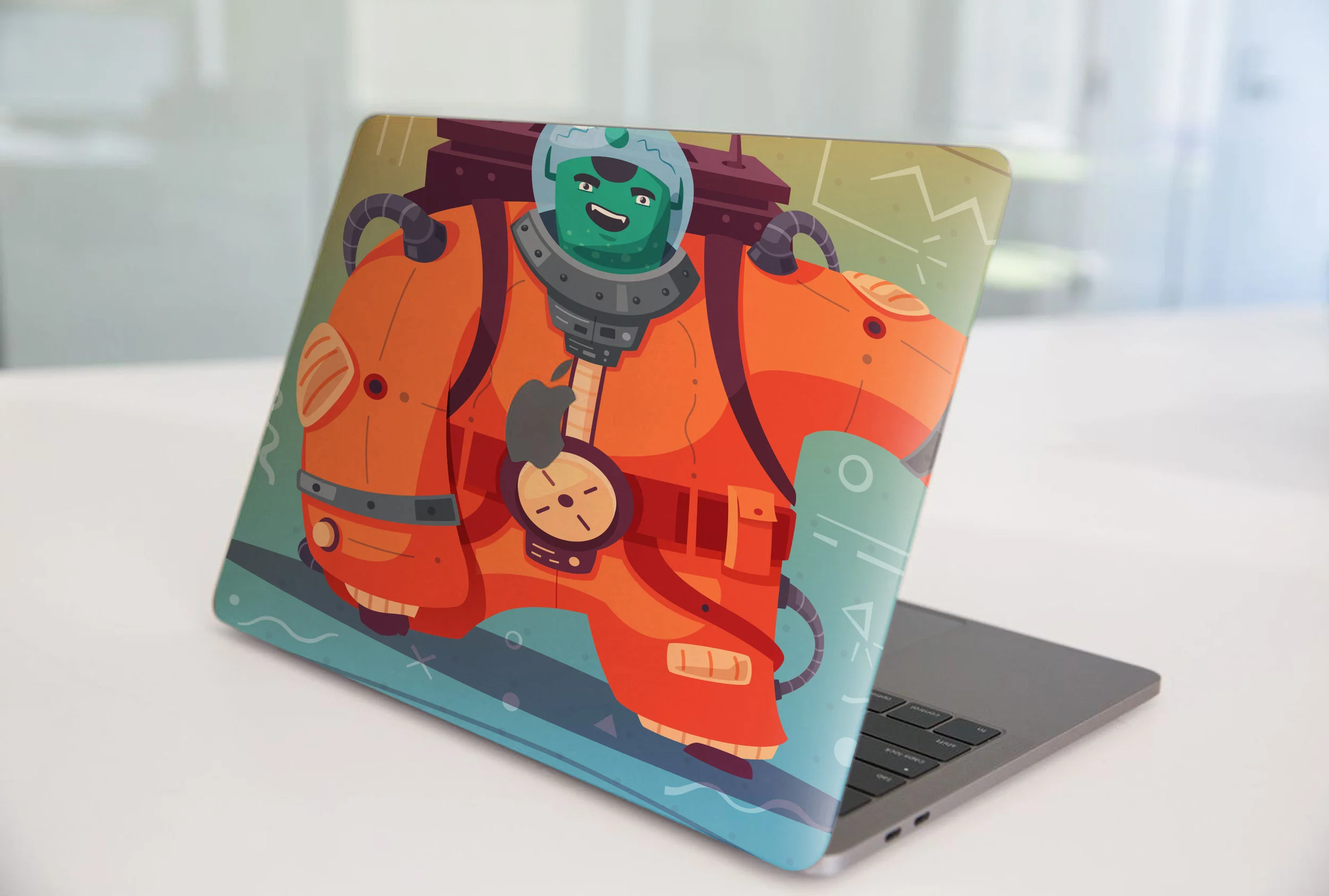 custom wrapped macbook pro with 3M vinyl with lamination of an alien by Print Hub a Miami sign shop