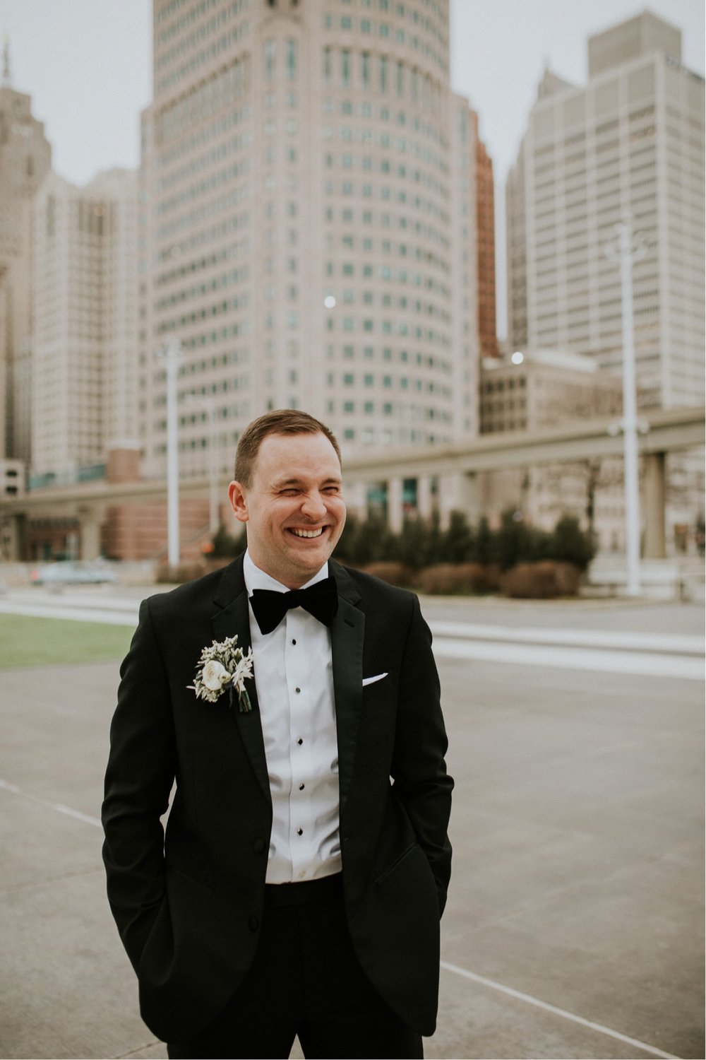 42_Steph Photo Co (63 of 123)_The groom laughing in downtown Detroit.jpg