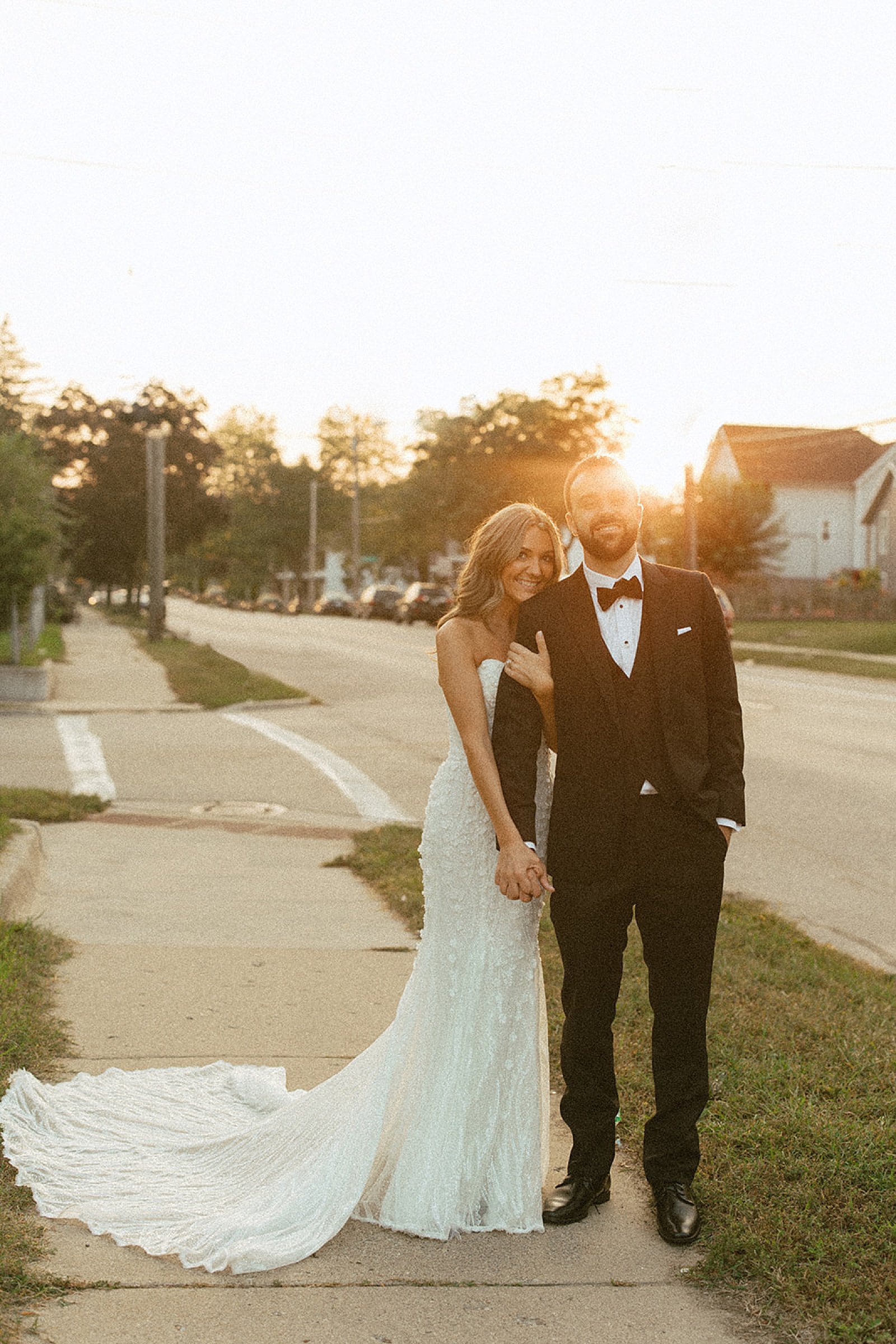  newlyweds at golden hour in neighborhood by Michigan wedding photographer 