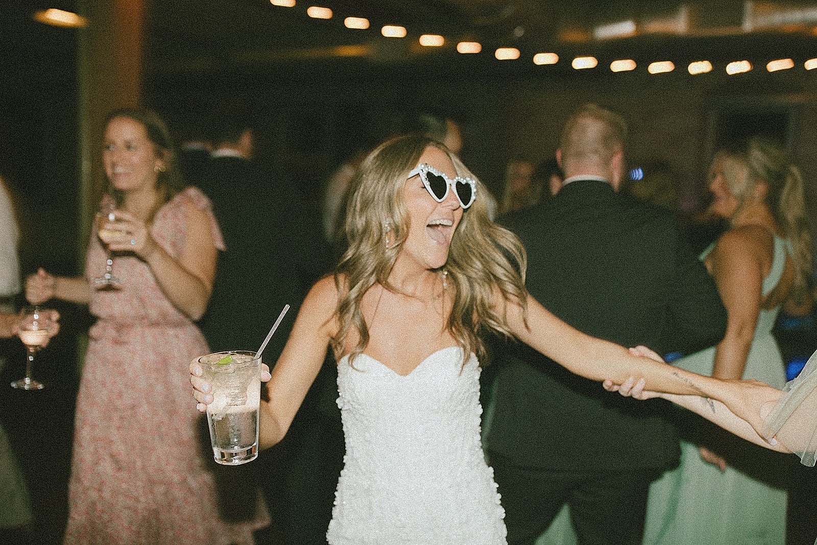  bride in sunglasses dancing by Michigan wedding photographer 