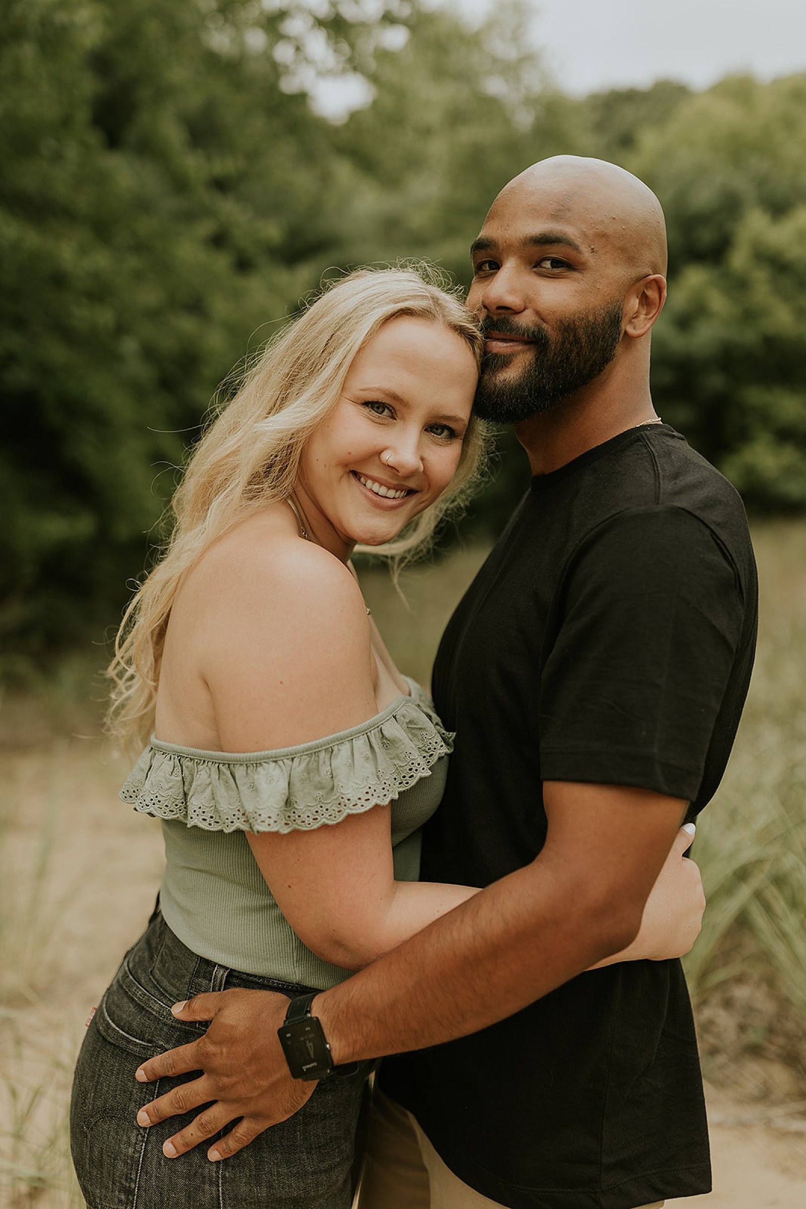  couple embracing outside at Grand Haven Engagement session 