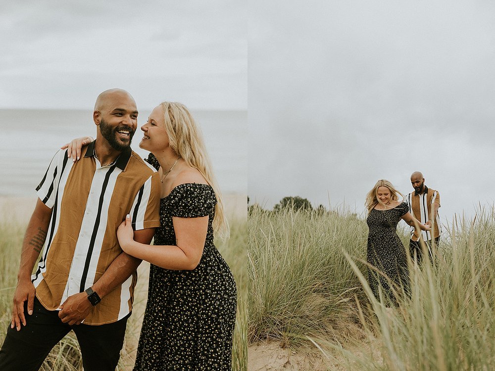  man and woman snuggled up on beach by Michigan wedding photographer  