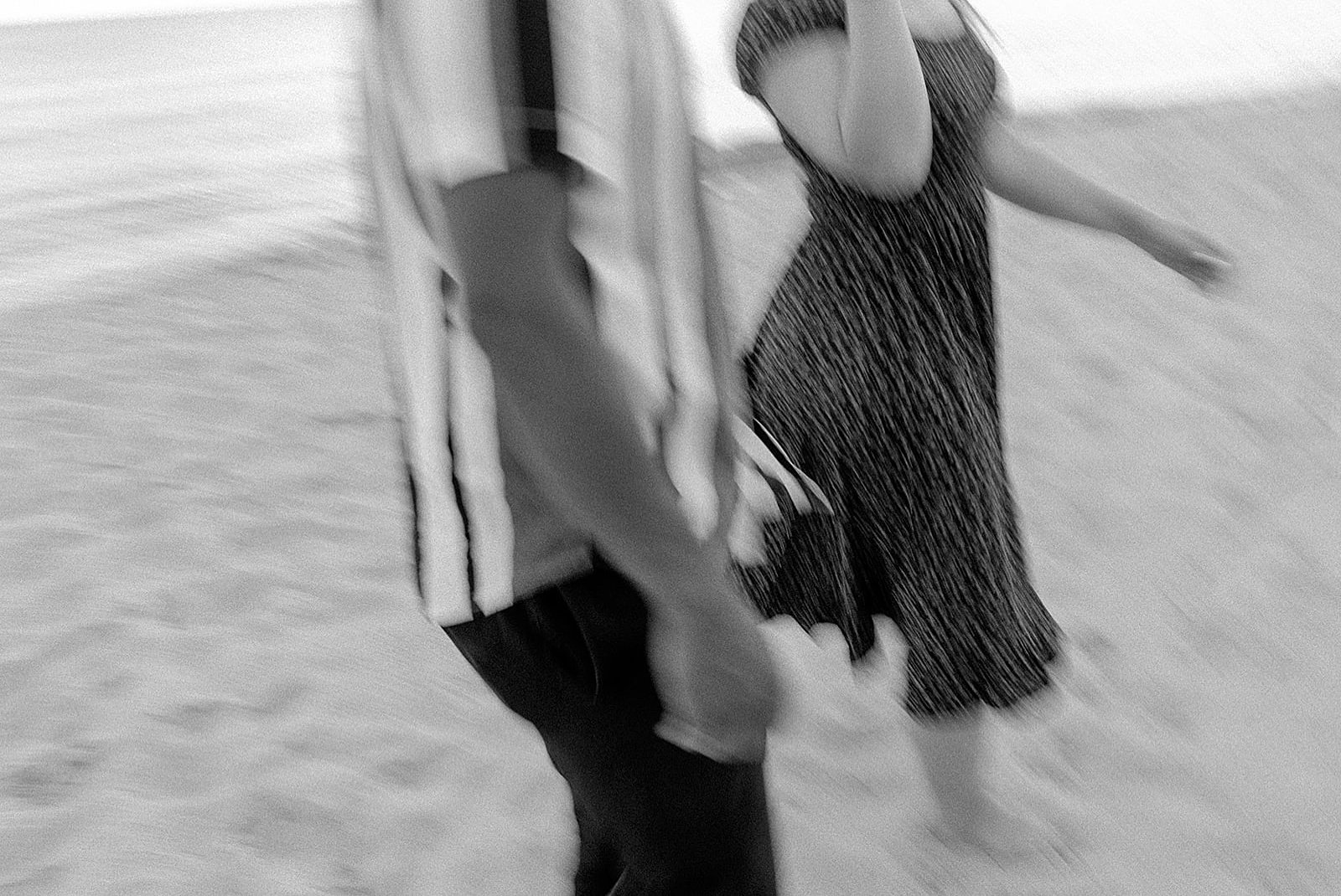  man and woman walking on the beach by Michigan wedding photographer  