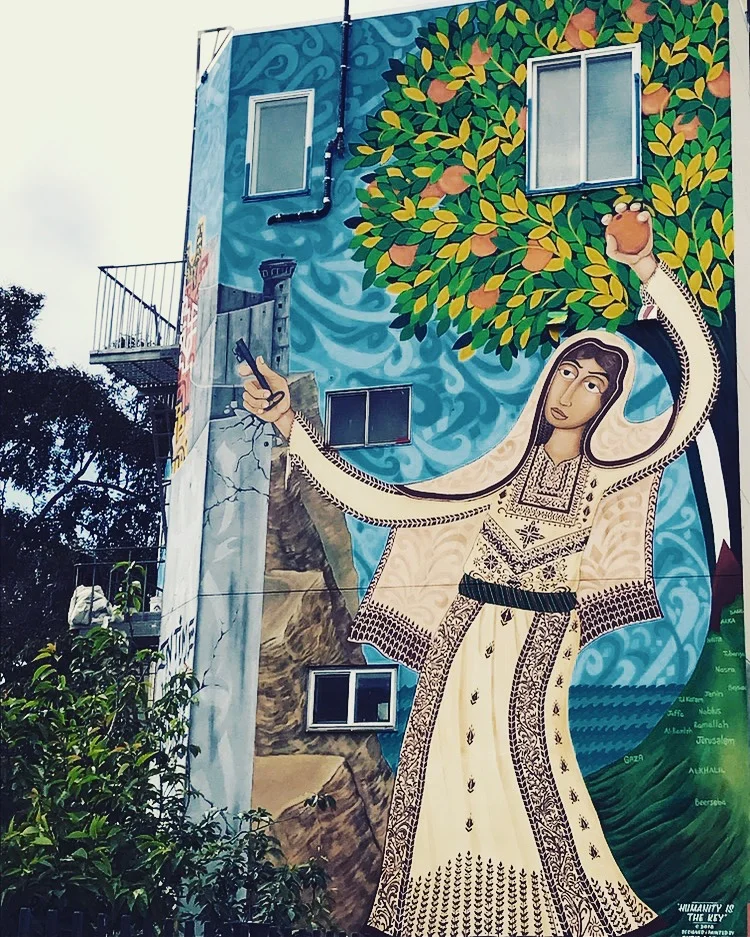 Amal holding the key of return, and an Yaffa orange. 