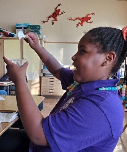 girl holding cup of handmade sanitizer - October 2020.jpeg