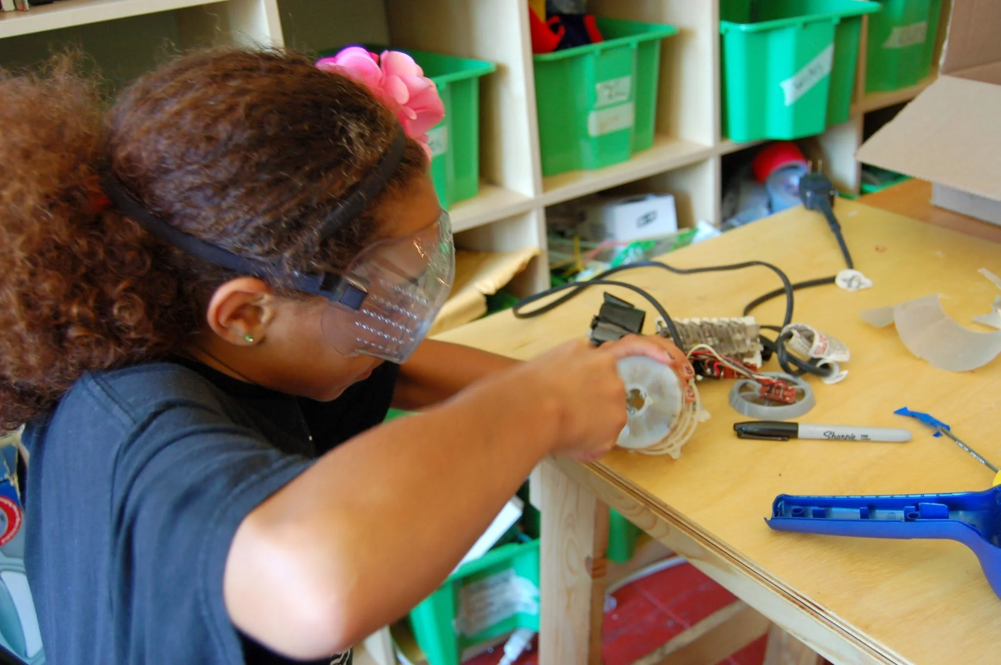 Girl in goggles repairing something - July 2014.JPG