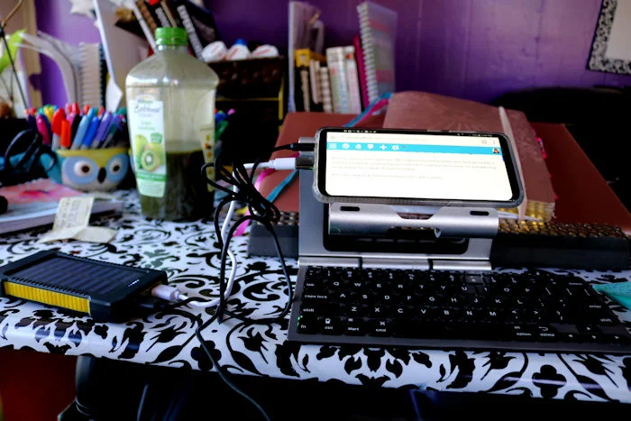 My phone, a wireless keyboard, headphones and a solar charger to power it all. It's awkward, but at least get work done.
