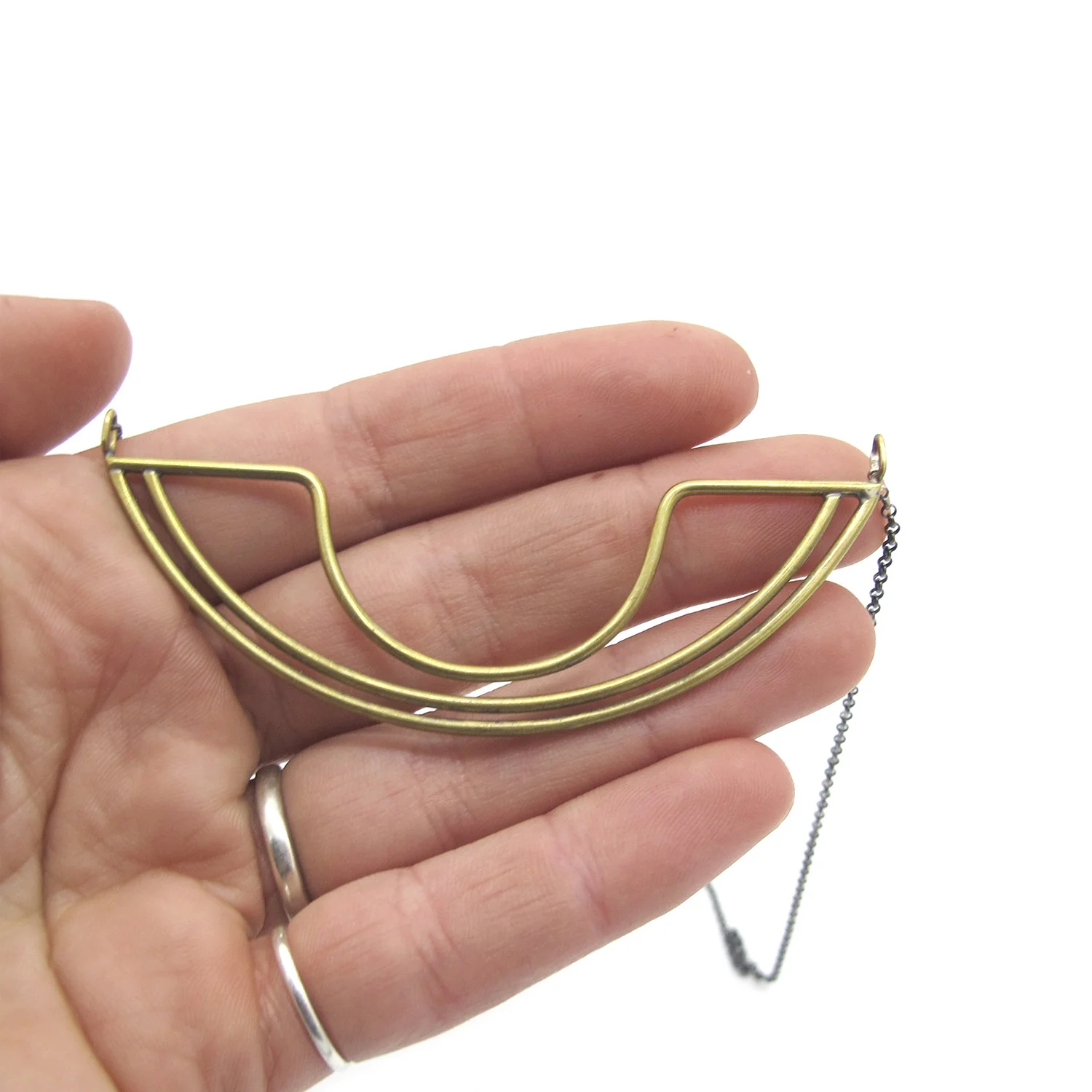 curvednecklacehand copy.jpg