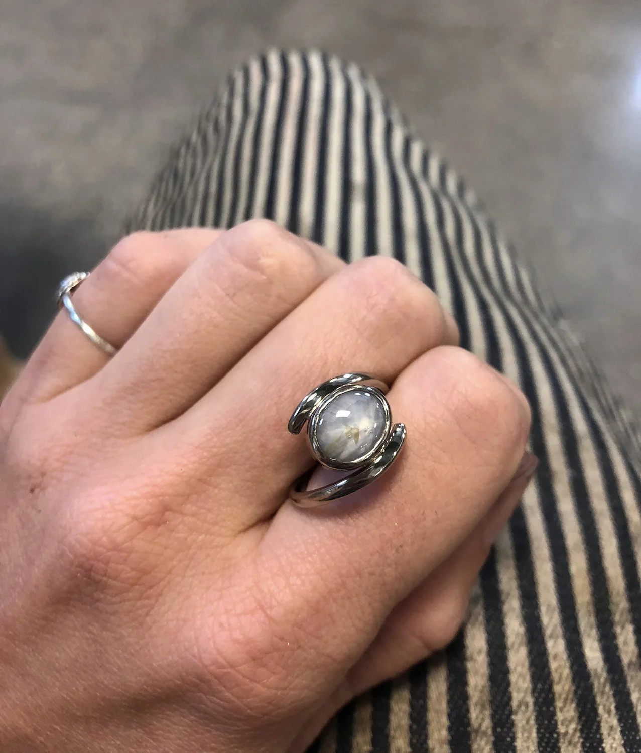 Engagement ring with a rutile included star sapphire set in an 18k white gold palladium band.