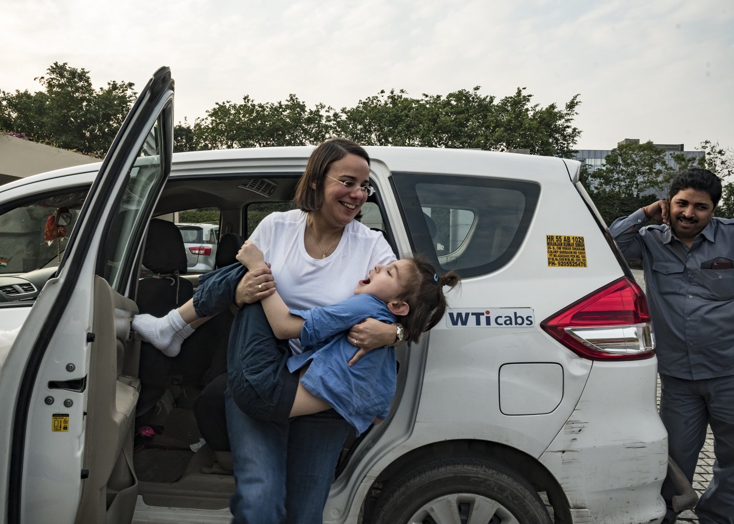 26. Iris lifts Kereni from the car to her wheelchair | NIK_1163.jpg