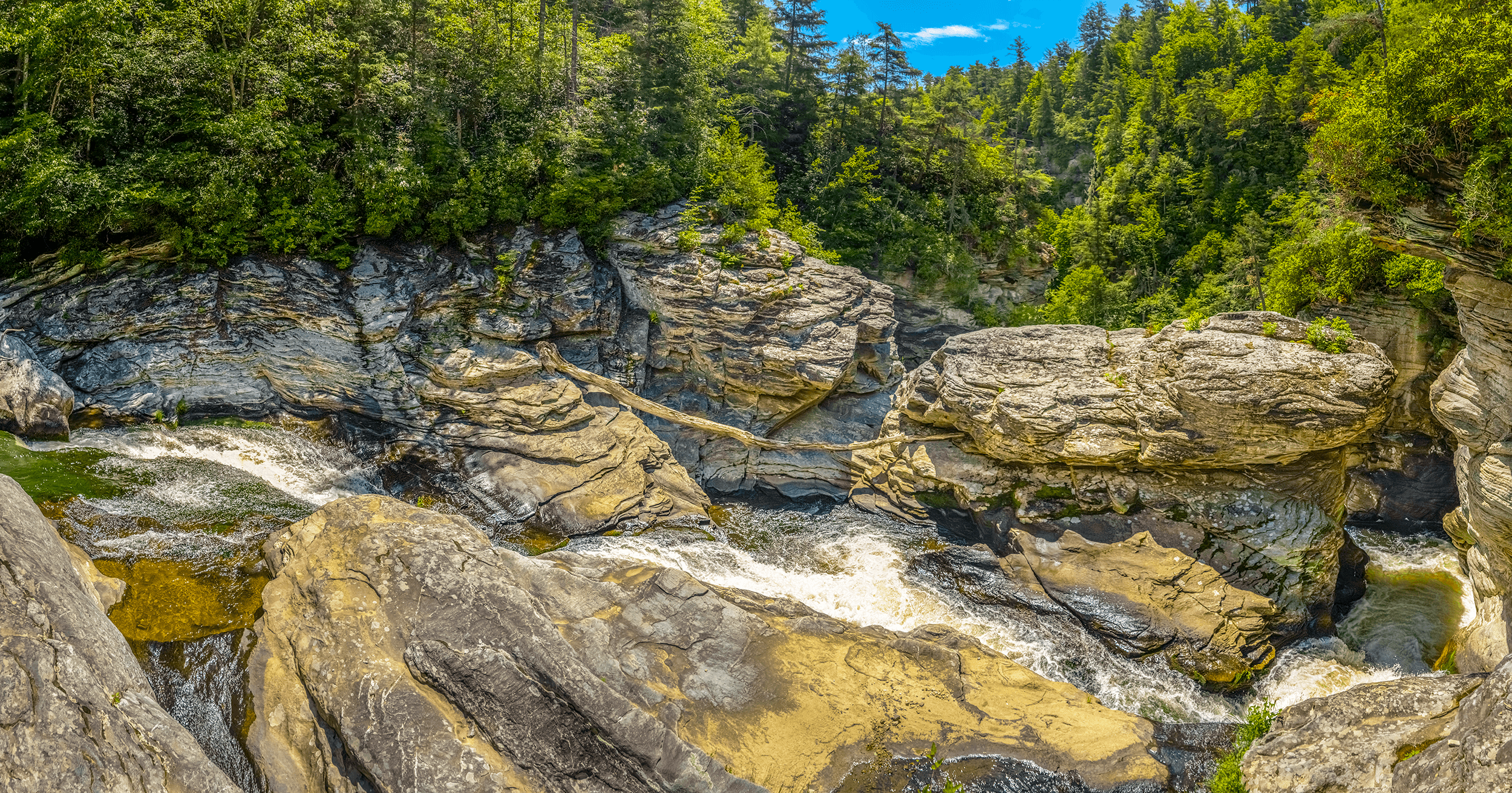 ...dramatically flowing into a narrow canyon, spiraling out of sight and...
