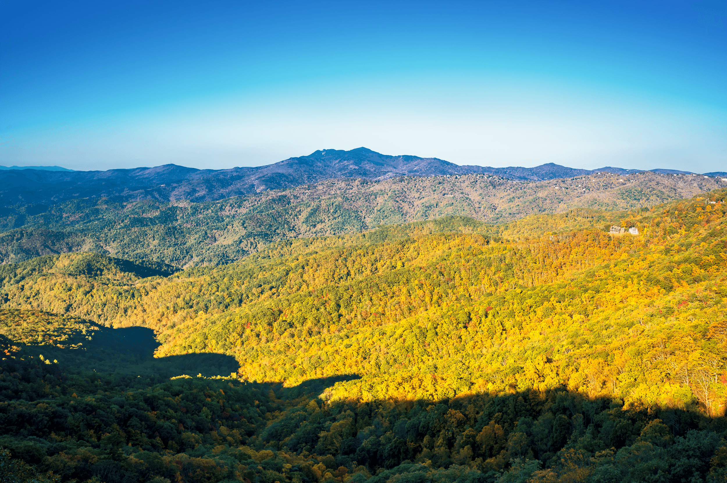 Grandfather Mountain , here in view in the center of the image, is 5,946 feet (1,812 m) high. The mountain features the famous Mile High Swinging Bridge , which at 5,280 feet above sea level is the most elevated suspension footbridge in the U.S. To the left is Grandmother Mountai n and to the right is Beech Mountain .
