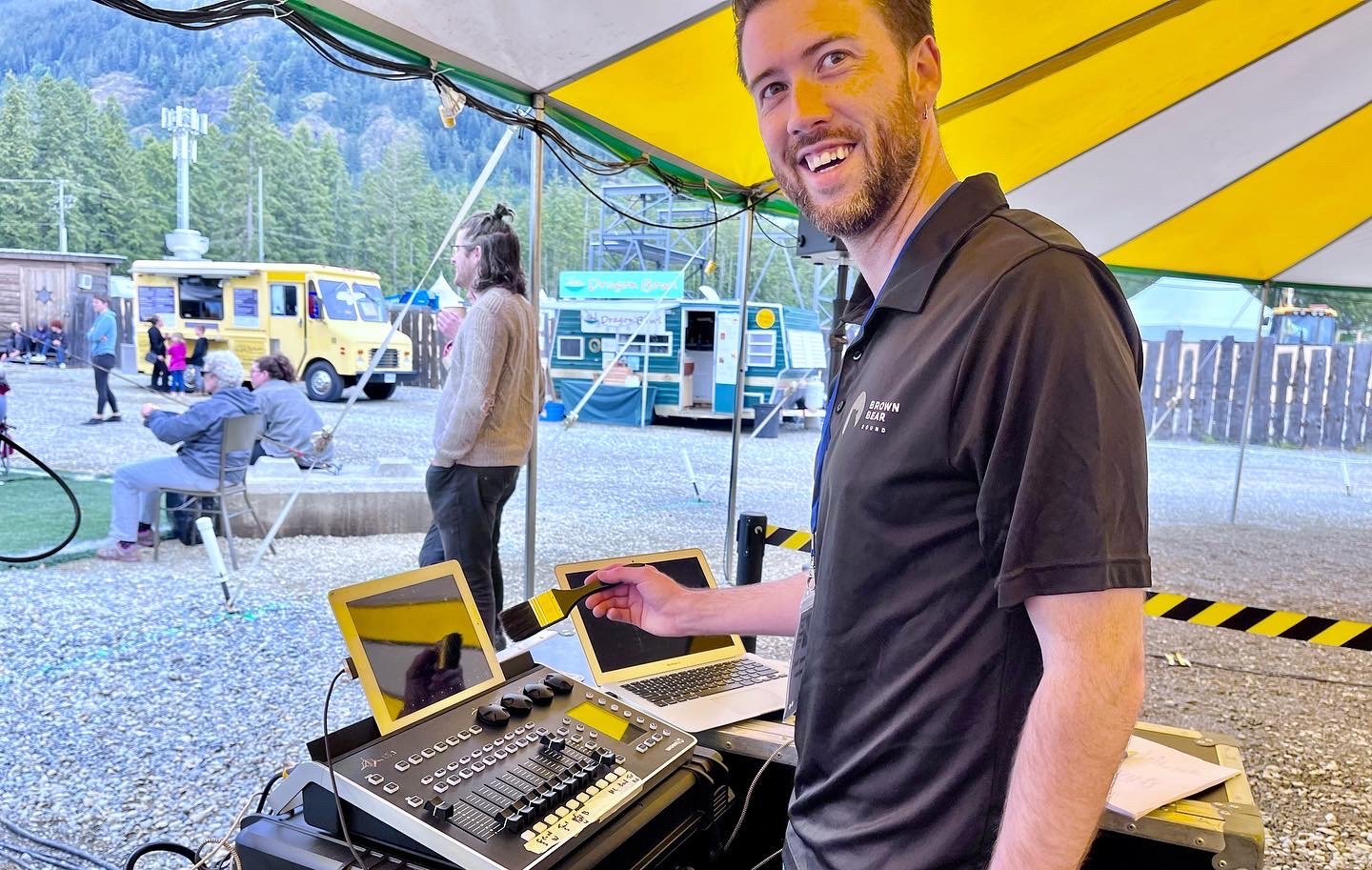 Owner Jeremy Young dusting off the Lightshark LS-1 Lighting Controller at the Cowichan Valley Bluegrass Festival, Lake Cowichan 2022