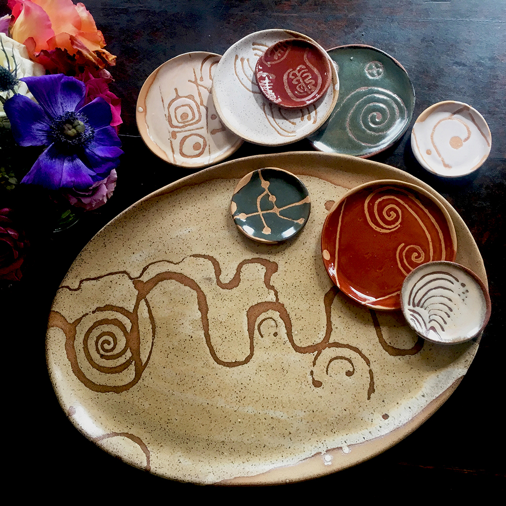  large platter with créme brûlée on speckled clay accompanied by assortment of 5” &amp; 3” plates 