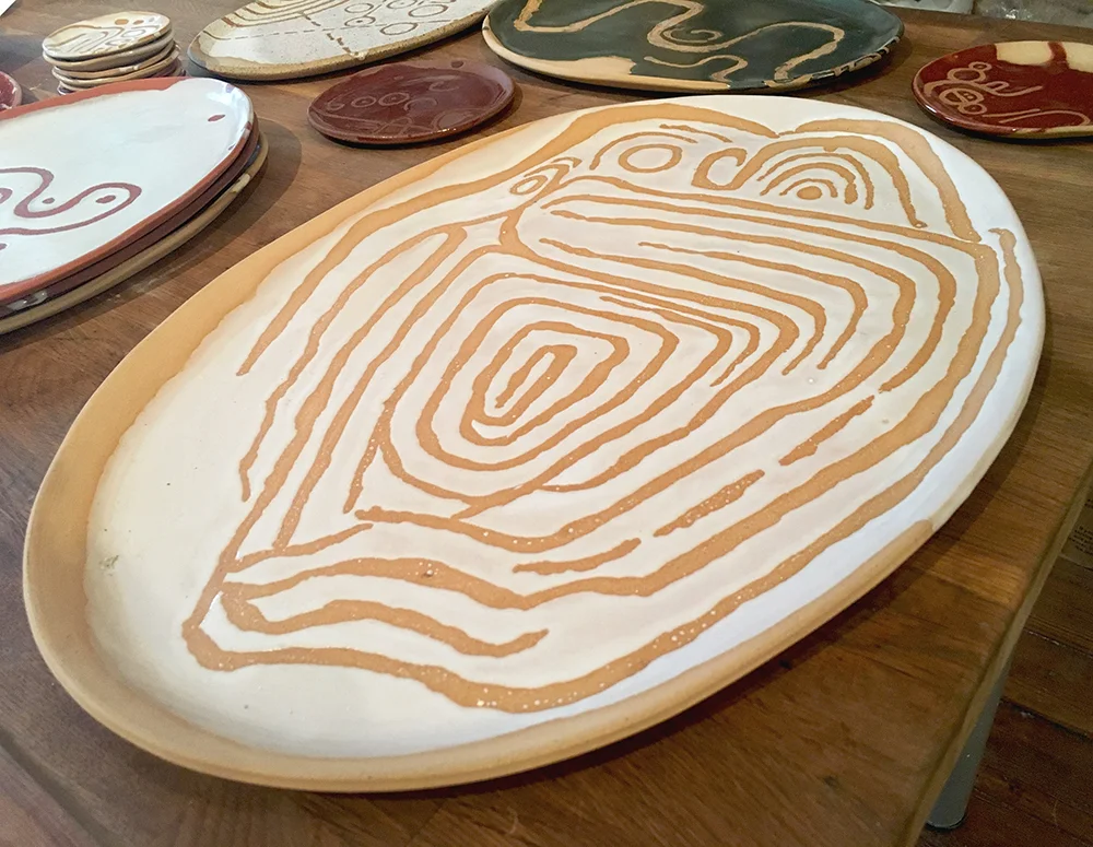large platter: owl calendar neolithic petroglyph in white on blush clay