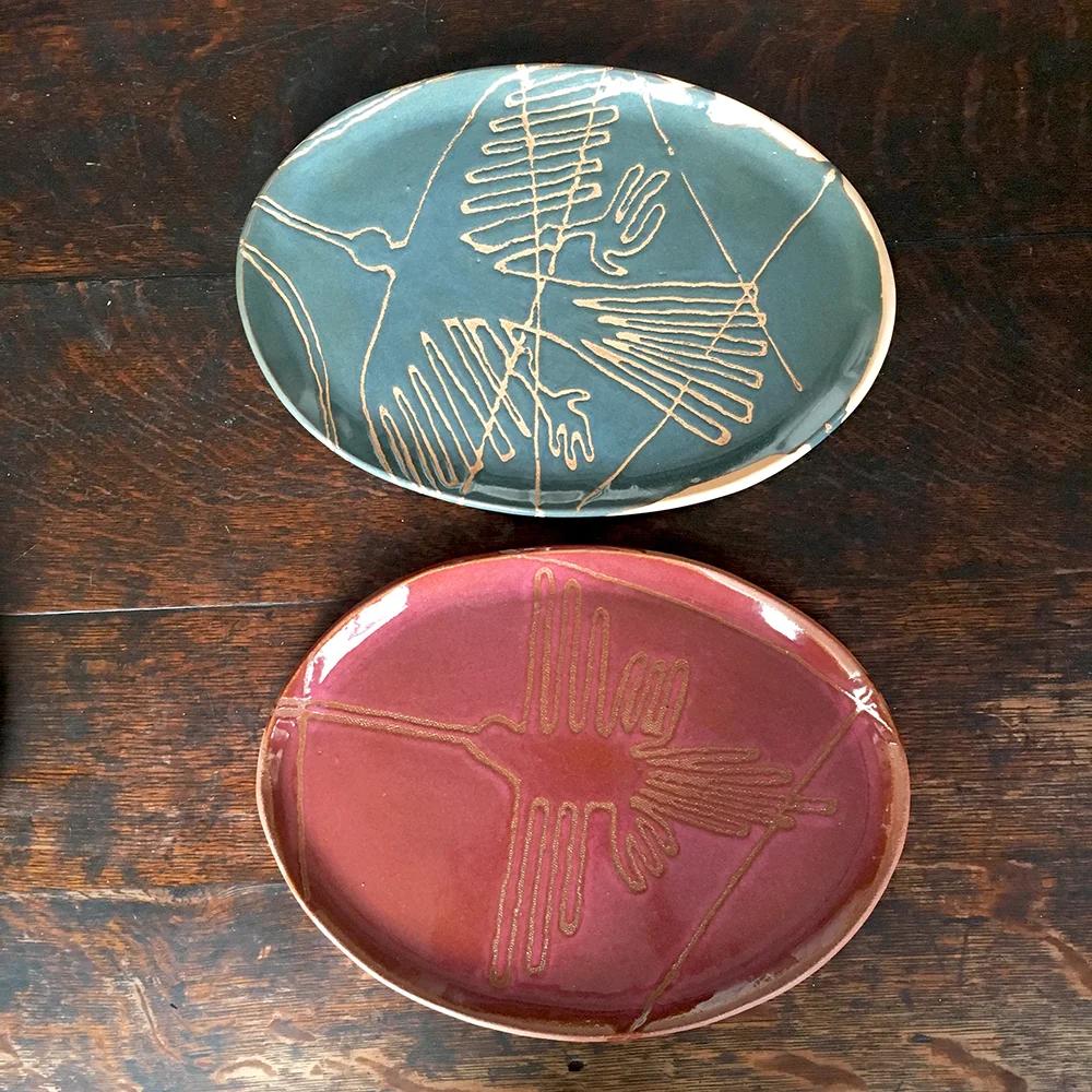 custom small plates with nazca lines (peru) in moss on blush clay & plum on red clay