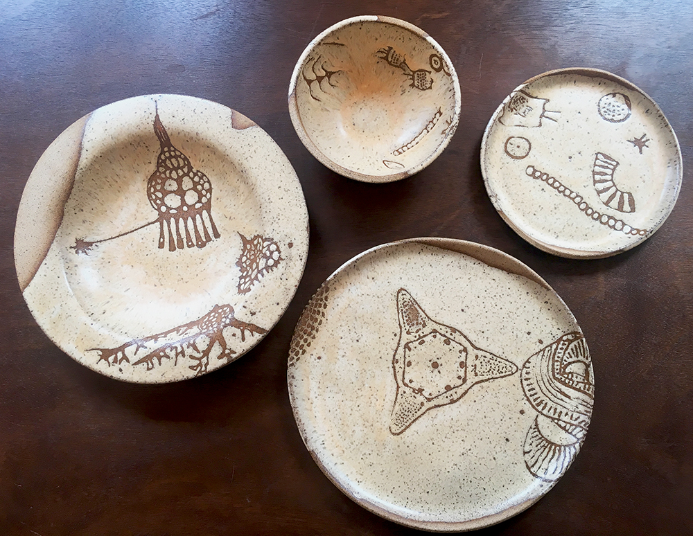 custom place setting with dinner & 7” plates, low & small bowls in créme brûlée on speckle clay