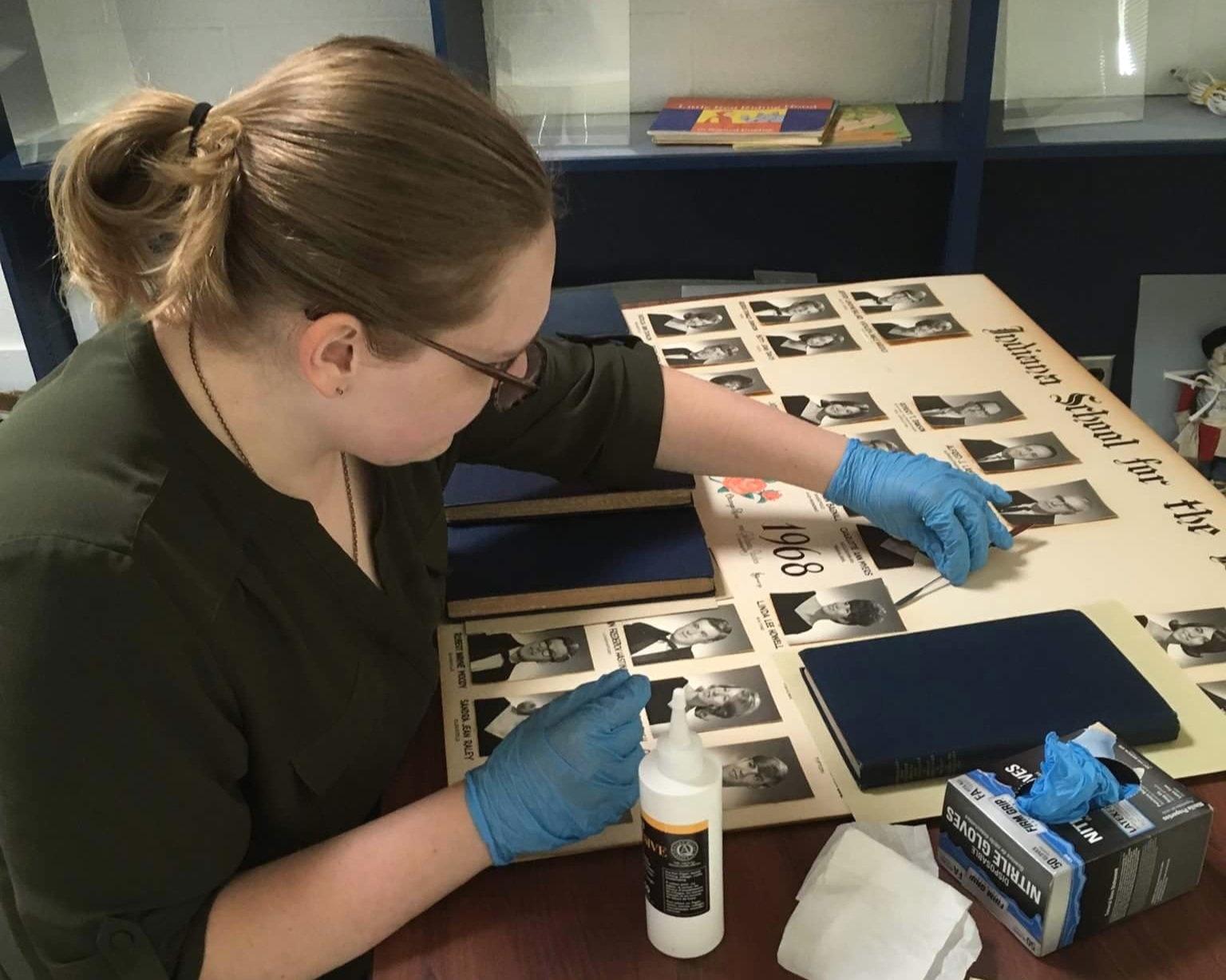 At the beginning of my internship, I worked on repairing graduation posters. Many of the photographs of students had fallen off, were loose, or the original adhesives were causing issues. During this time, I also cross-referenced the graduates wit