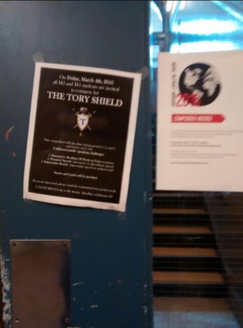  This is a photo of two posters advertising extracurricular events taped to the door of the staircase across from my locker. Every day, students are bombarded with emails inviting them to all sorts of clubs and events and surrounded by posters such a