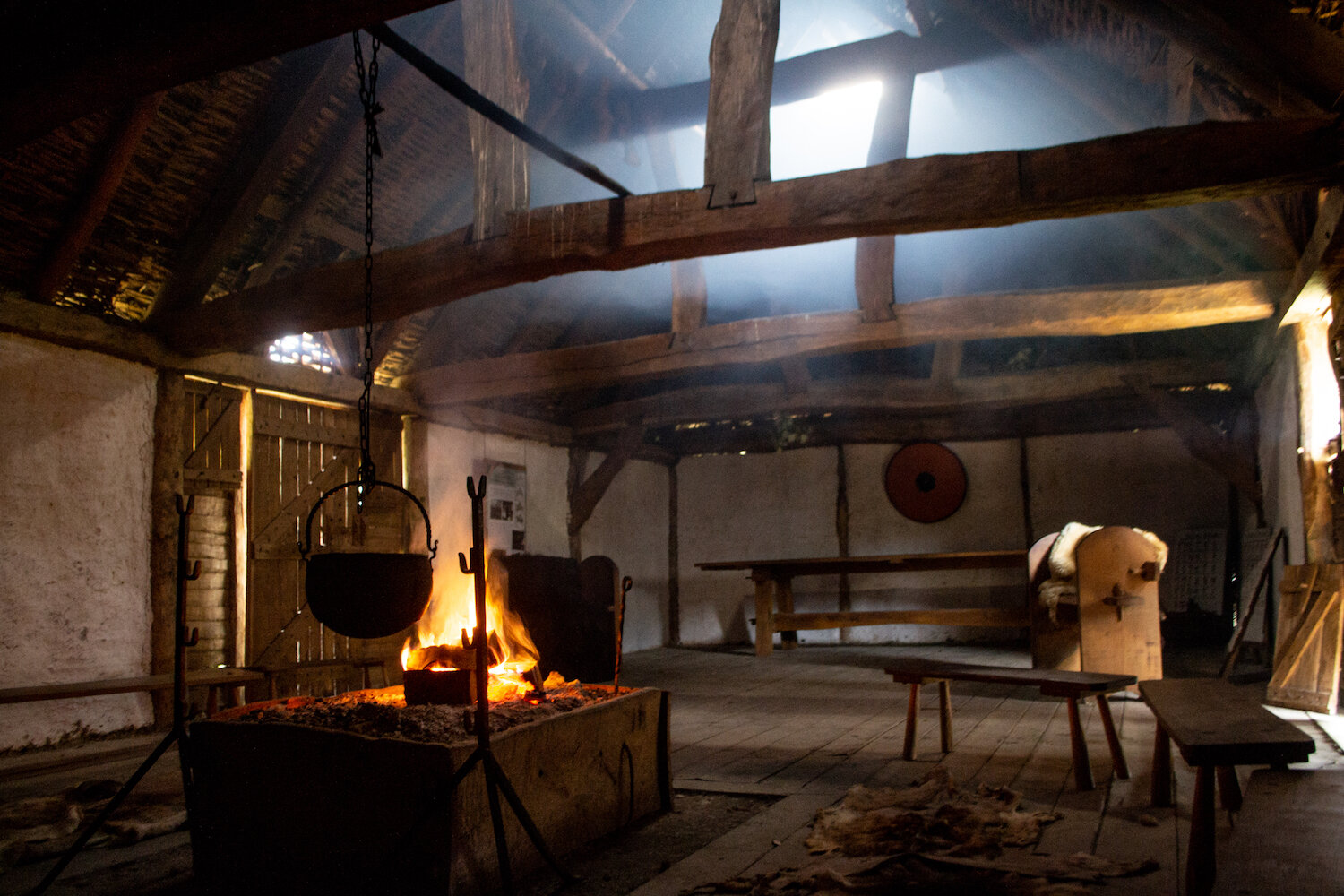 Butser Ancient Farm Saxon Hall with fire and smoke