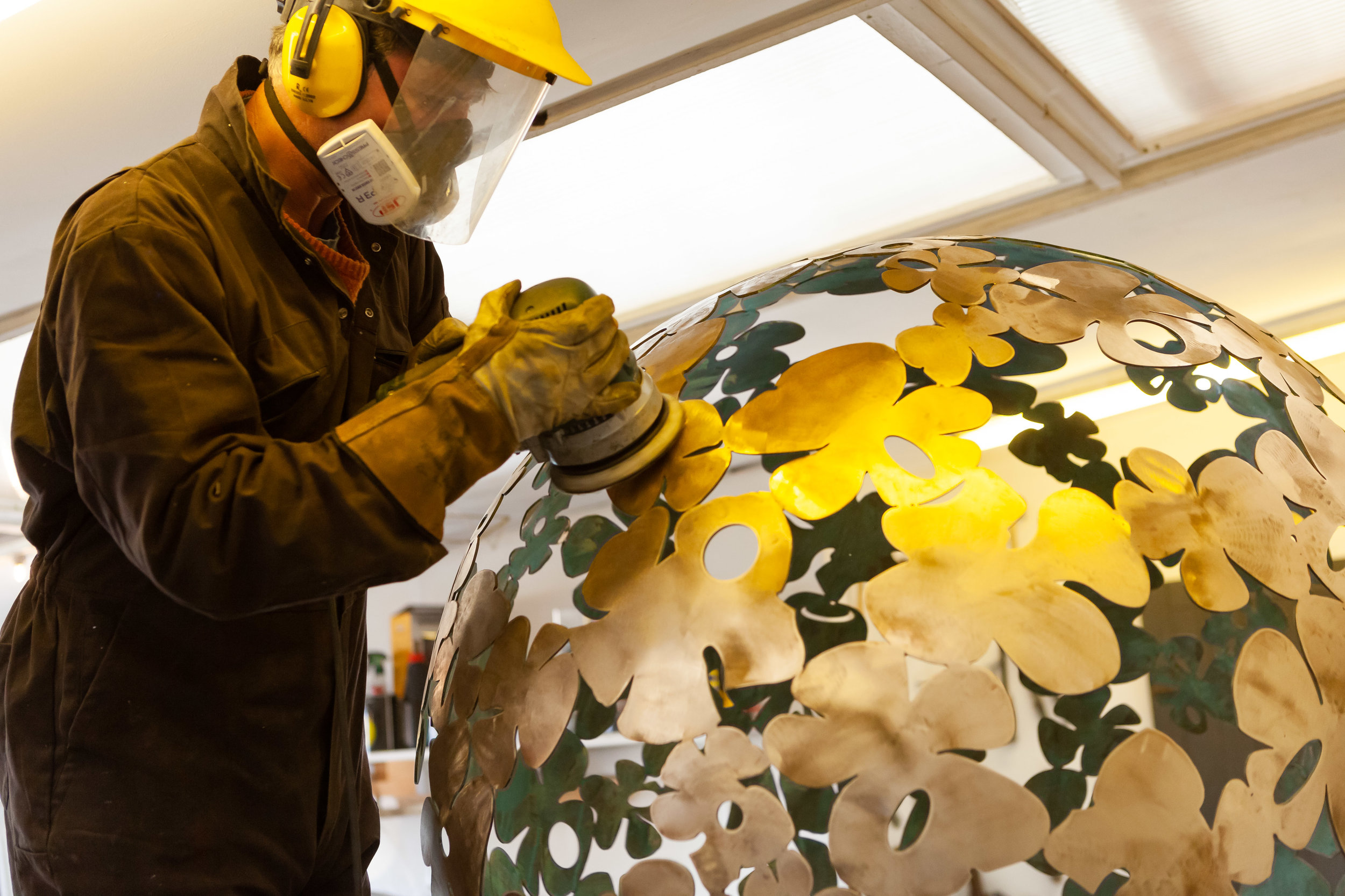 The sphere is sanded and polished until the brass is perfectly smooth.