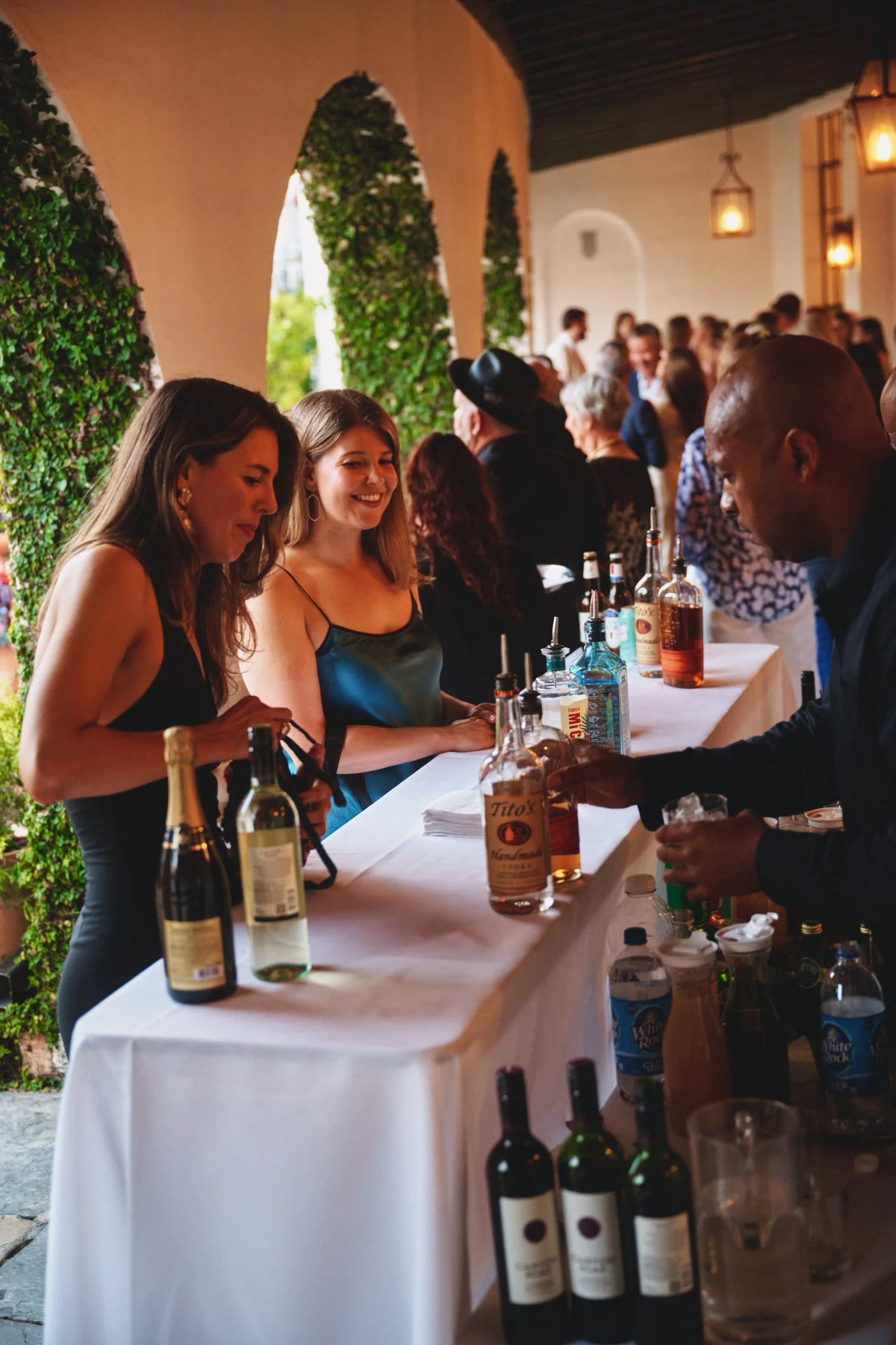  Guests being served at the courtyard bar under the ivy arches at Il Mercato in New Orleans 