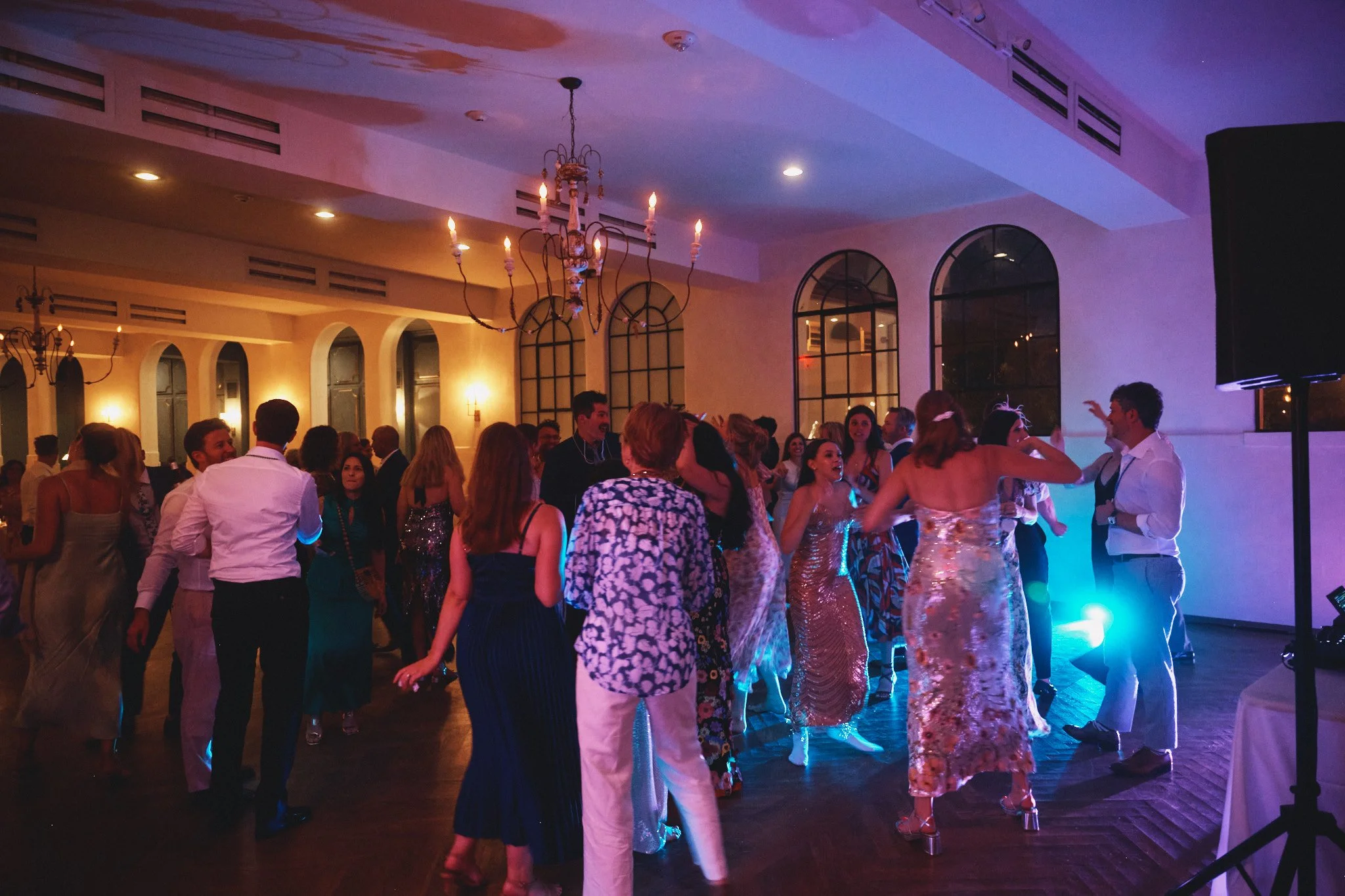  Guests filling the dance floor under the chandeliers at Il Mercato in New Orleans 