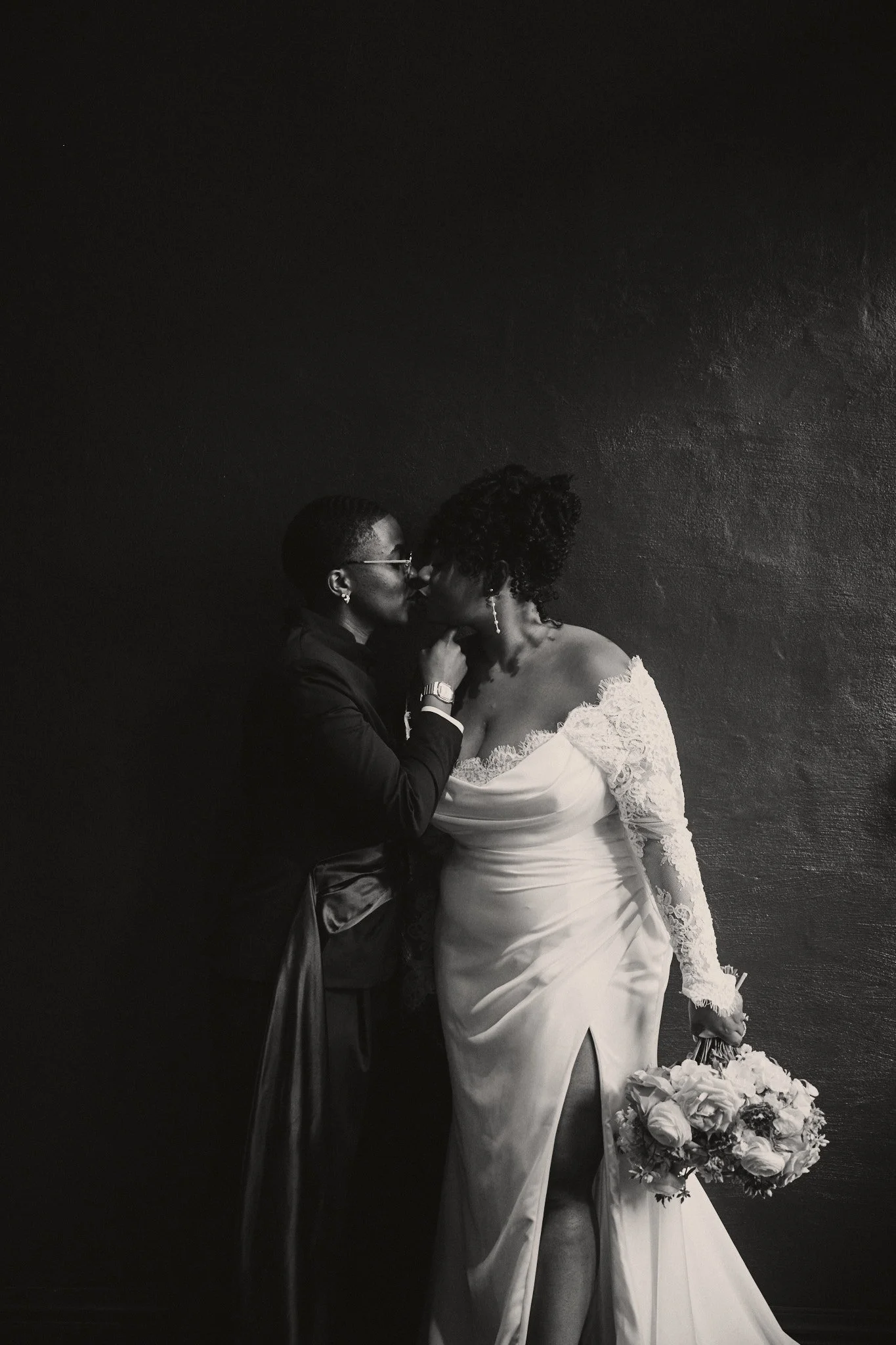  A couple embracing against the exposed plaster walls at Capulet in New Orleans 