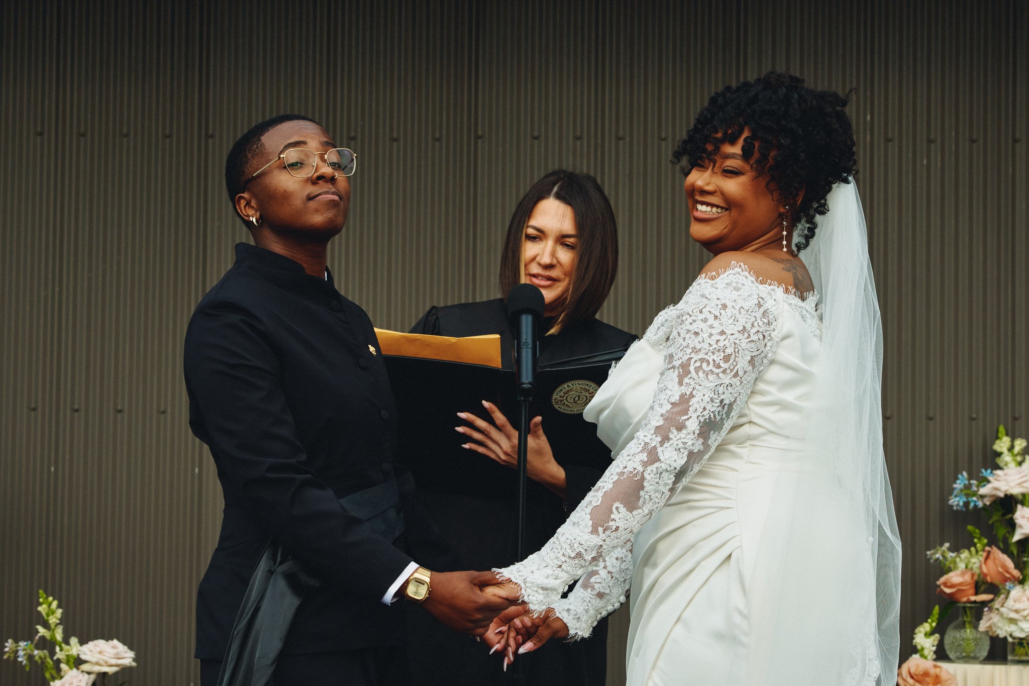  A couple holding hands during their vows at their rooftop ceremony at Capulet 