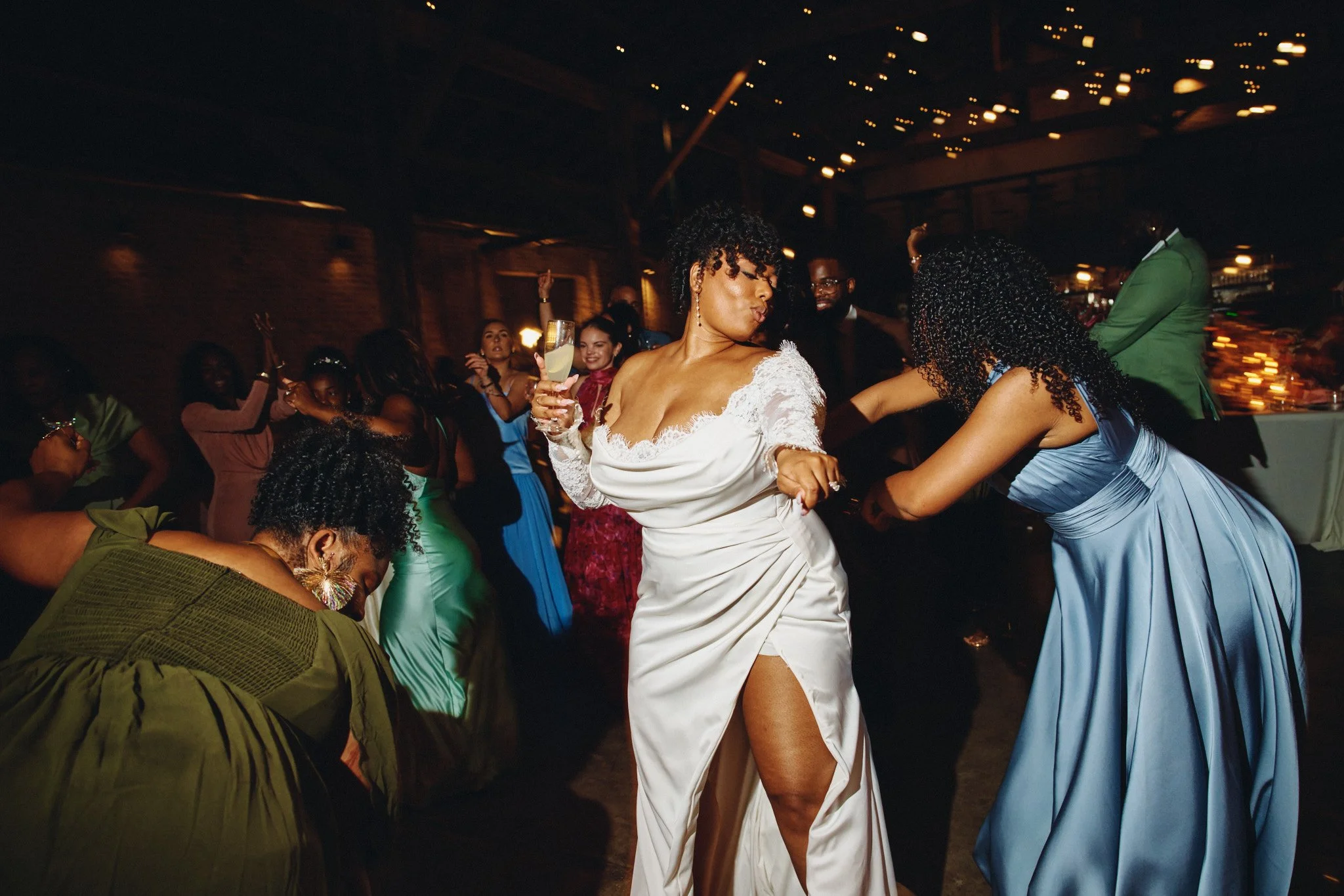  Guests dancing under string lights at a wedding reception at Capulet 