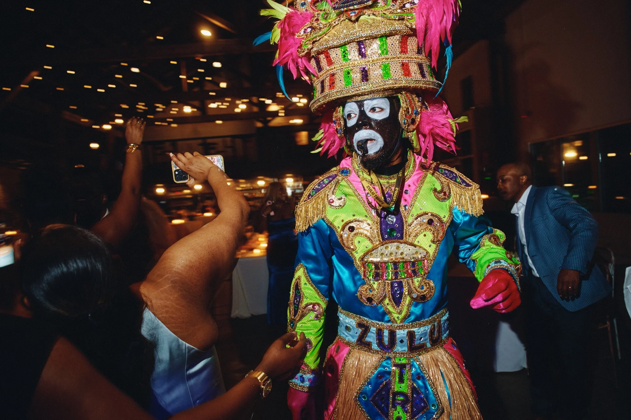  Zulu Warrior in full costume among the crowd during a wedding second line 