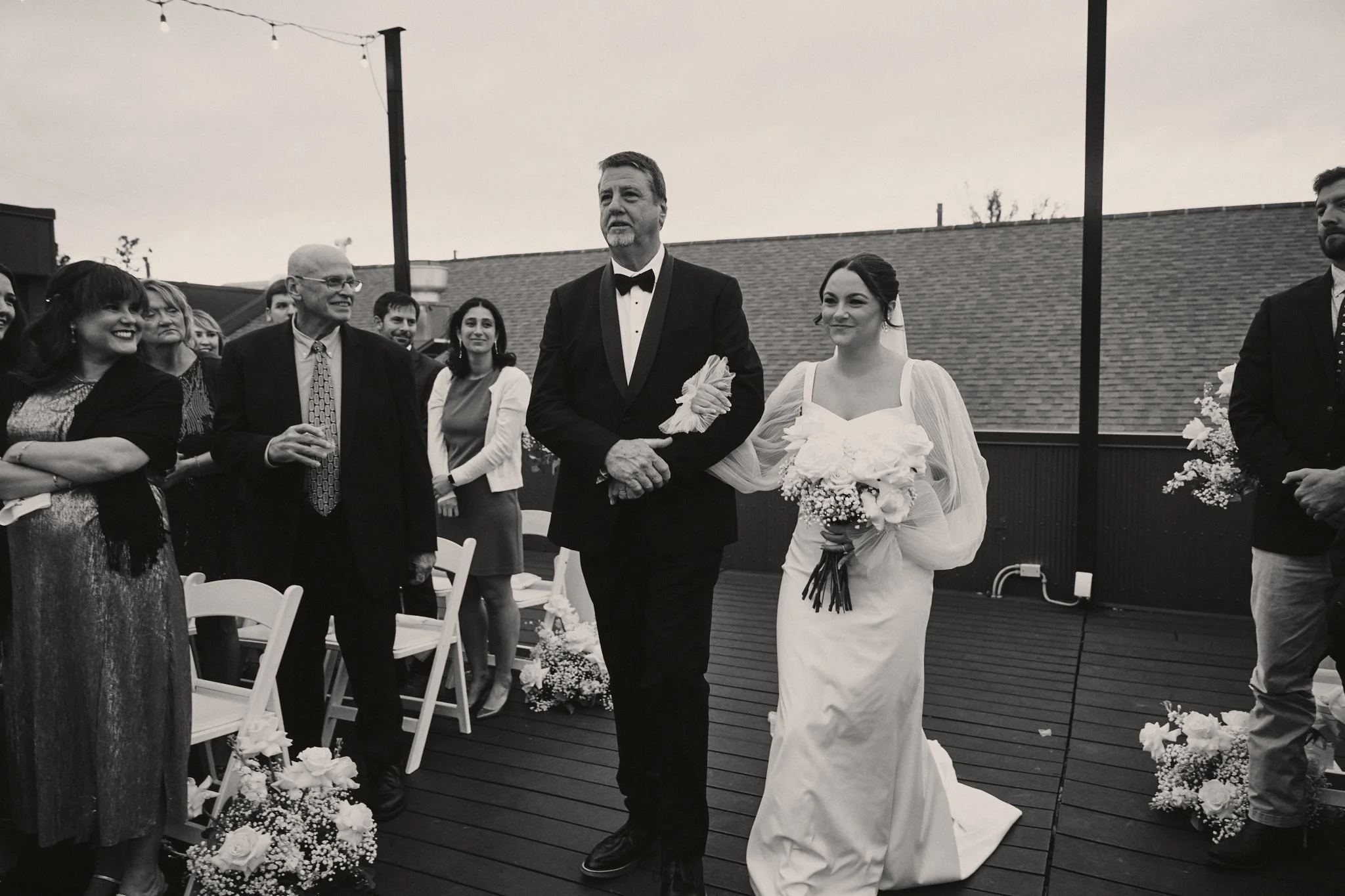  A bride walking up the rooftop aisle on her father's arm at Capulet in New Orleans 
