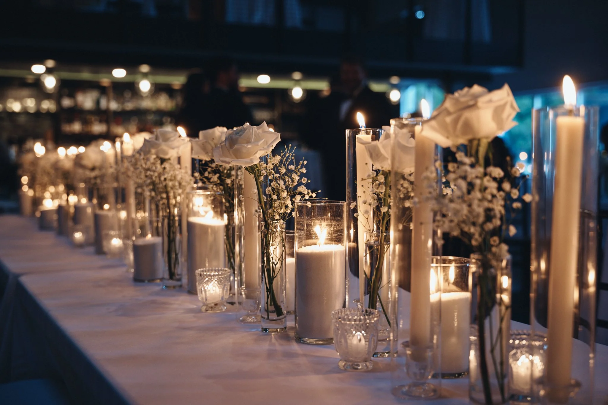  Taper candles and white roses lining the bar at the reception at Capulet in New Orleans 