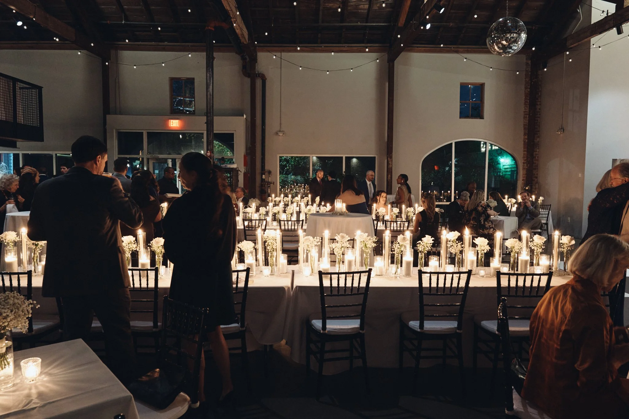  The candlelit head table set beneath the exposed beams at the reception at Capulet in New Orleans 