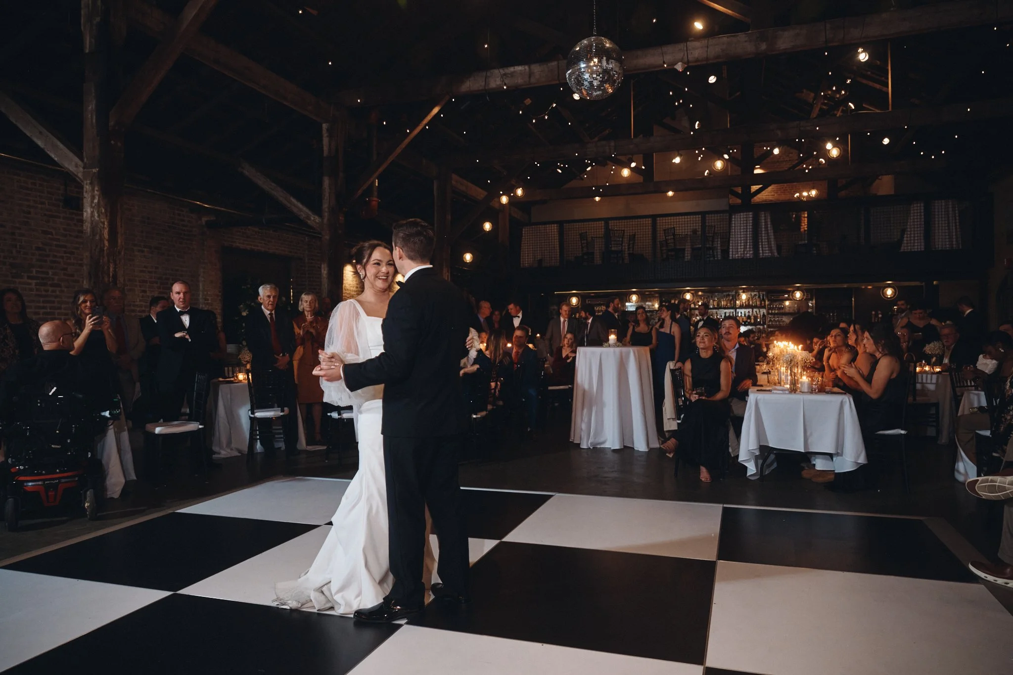  A bride and groom's first dance on the black and white checkered floor at Capulet in New Orleans 
