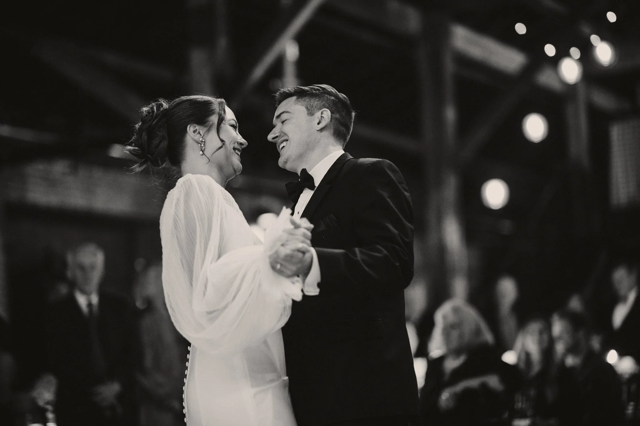  A bride and groom laughing together during their first dance at Capulet in New Orleans 