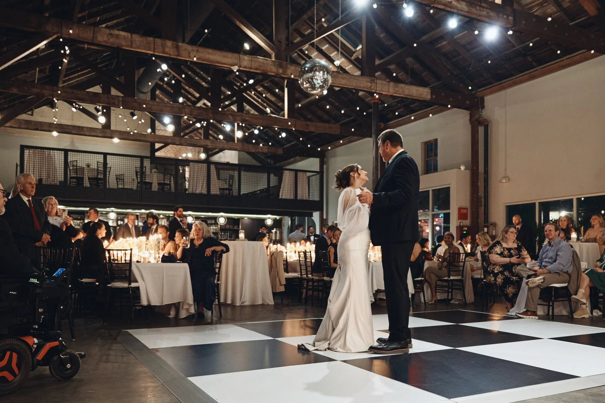  A bride dancing with her father on the checkered dance floor at Capulet in New Orleans 