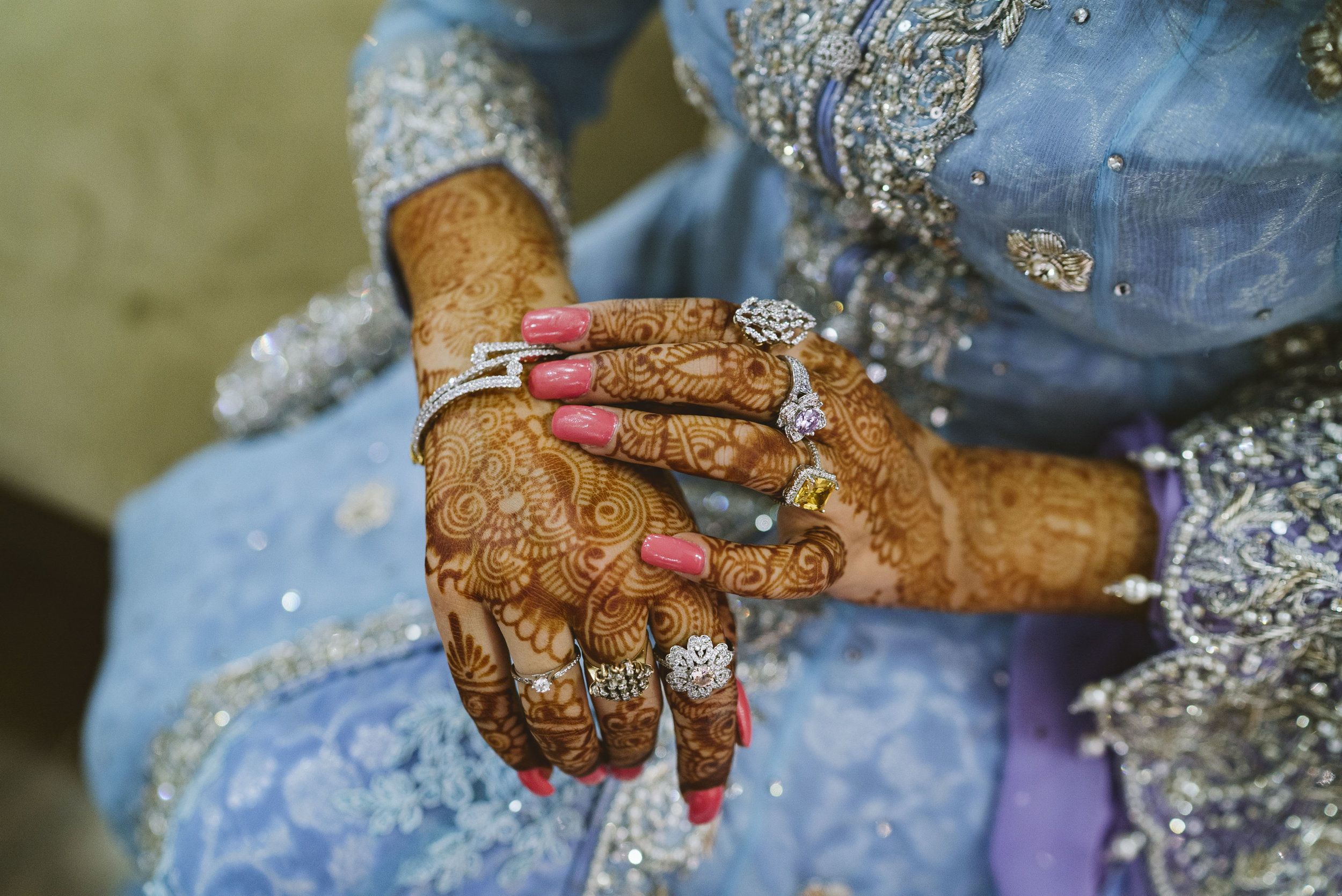  Newlywed Ayesha Sadal adjusts her jewelry before heading to the  walima  for Sadaf and Kashif Malik. The  walima  is a wedding tradition in which the groom's side provides a large feast to the bride's family and other guests. Beforehand, on the day 